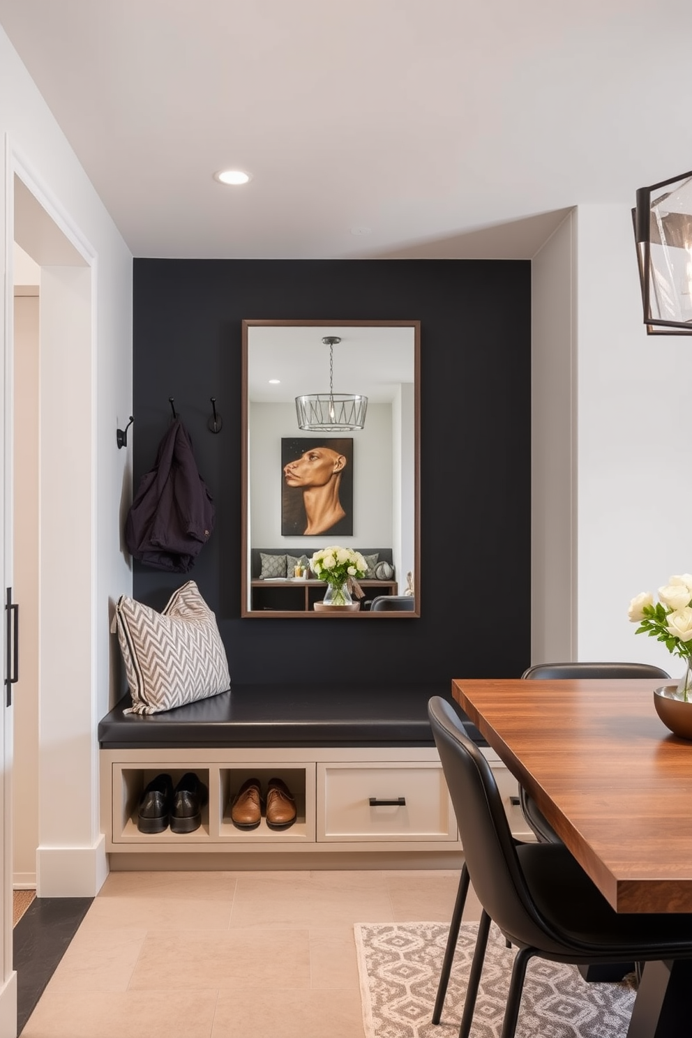 A cozy mudroom adjacent to the dining room features a small fridge for drinks, seamlessly integrated into the cabinetry. The space is designed with built-in benches and hooks for coats, accented by warm wood tones and soft lighting.