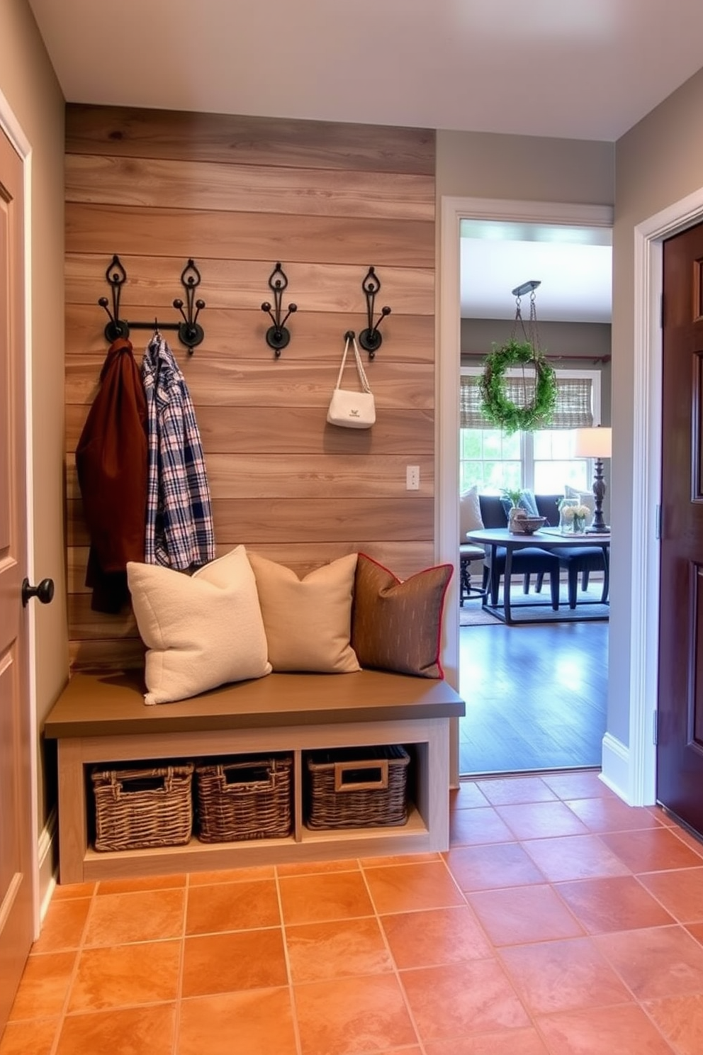 A cozy mudroom adjacent to the family room features built-in wooden benches with soft cushions and hooks for hanging coats. The walls are painted a warm beige, and the floor is covered with durable patterned tiles that can withstand heavy foot traffic. To add a personal touch, a gallery wall displays family photos and artwork in various frames. A large potted plant sits in the corner, bringing life to the space while a stylish rug defines the area and adds comfort.