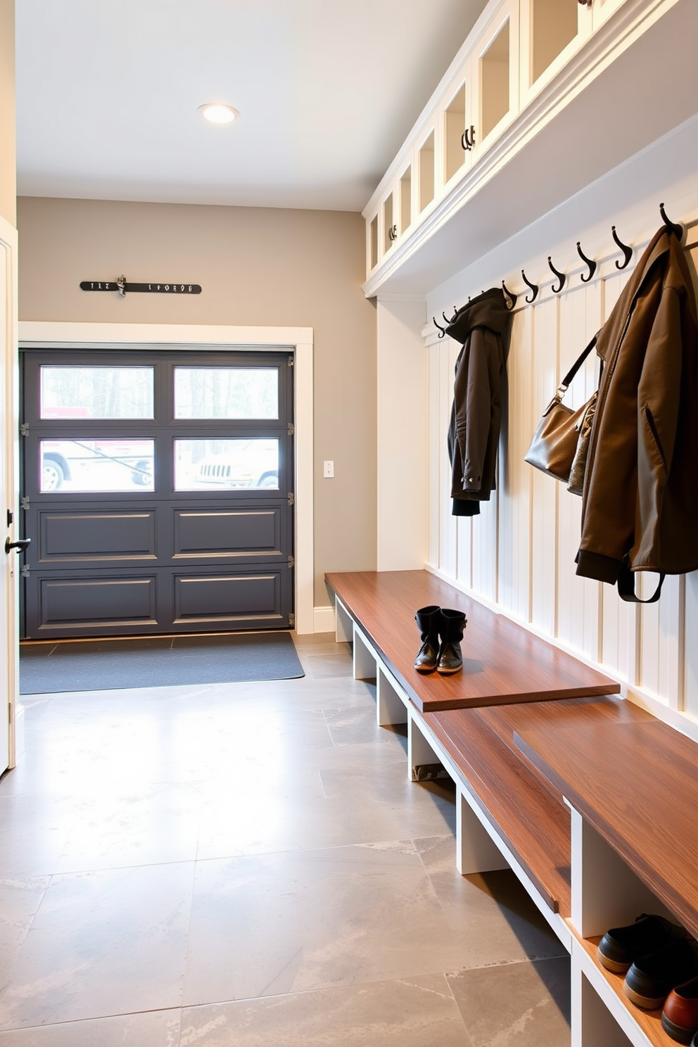 A functional mudroom near the garage features durable flooring designed to withstand high traffic. The space includes built-in storage solutions such as benches and hooks for easy organization of shoes and outerwear.