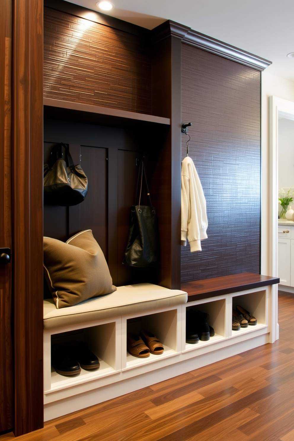 A stylish mudroom adjacent to the kitchen features built-in benches with plush cushions and ample storage for shoes and bags. Accent lighting illuminates the space, highlighting the textured wall panels and creating a warm and inviting atmosphere.