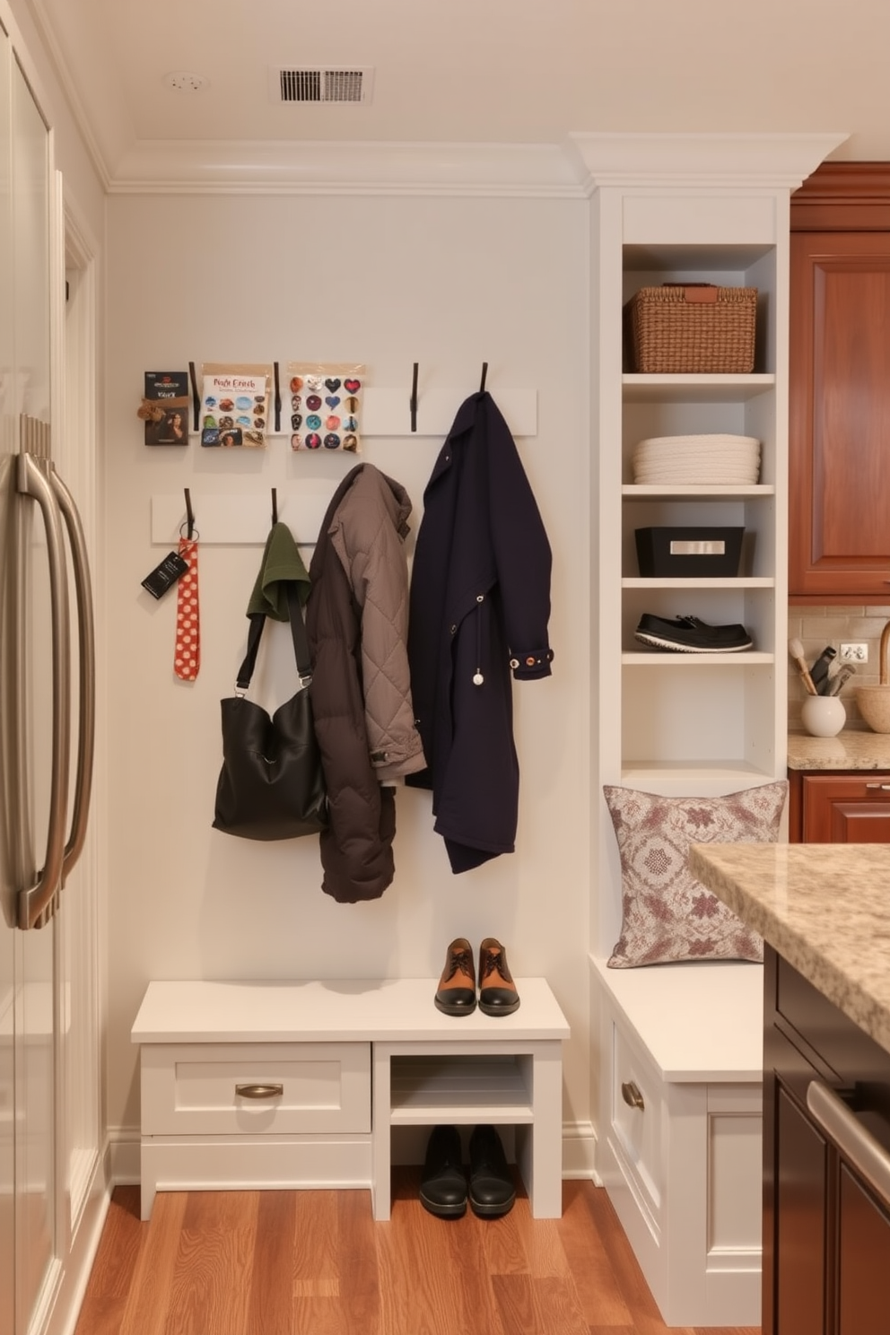 A functional mudroom design near the kitchen features wall-mounted organizers for small items. The space includes hooks for coats, shelves for shoes, and a bench for convenience, all in a cohesive color palette that complements the kitchen.