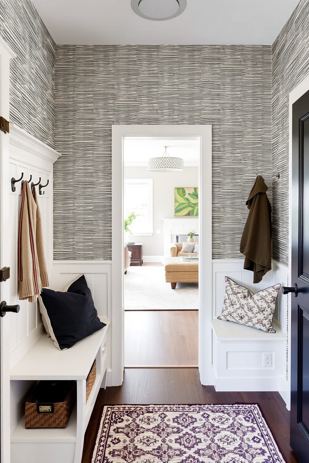 A welcoming mudroom near the living room features textured wallpaper that adds visual interest. The space includes built-in storage benches and hooks for coats, with a stylish area rug that complements the overall design.