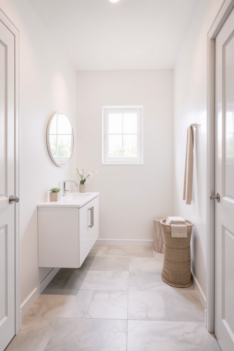 A narrow bathroom design featuring light-colored walls to enhance the feeling of space. The floor is adorned with large light gray tiles that create a seamless flow throughout the room. A sleek white vanity is positioned against one wall, topped with a simple round mirror that reflects natural light. Soft pastel accents in the decor add a touch of warmth without overwhelming the space.