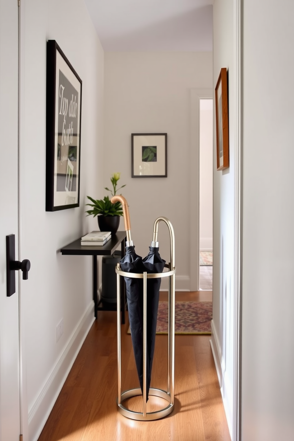 A chic umbrella stand is placed elegantly in a narrow entryway, crafted from sleek metal with a modern finish. The stand features a minimalist design, complementing the overall decor while providing practical storage for umbrellas. The entryway is adorned with subtle wall art and a narrow console table, enhancing the space's functionality. A small potted plant sits on the table, adding a touch of greenery to the stylish yet compact design.