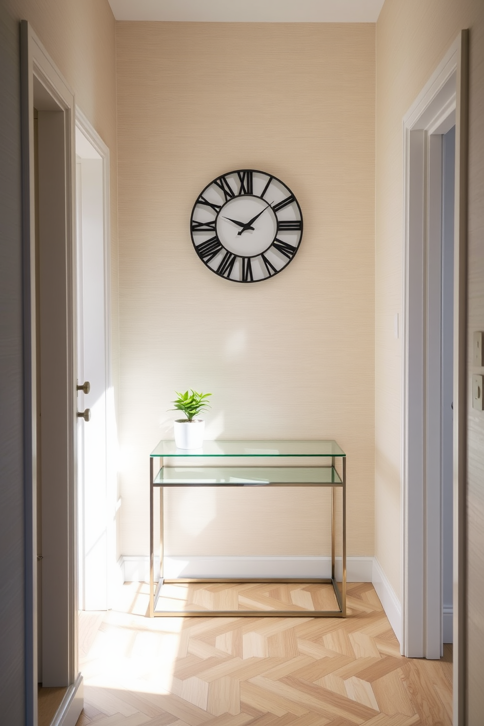 A stylish clock serves as the focal point in a narrow entryway. The walls are adorned with subtle wallpaper, and a sleek console table sits beneath the clock, complemented by a small potted plant. The floor features a herringbone pattern in light wood, enhancing the sense of space. Above the console, a round mirror reflects natural light, making the entryway feel more inviting.