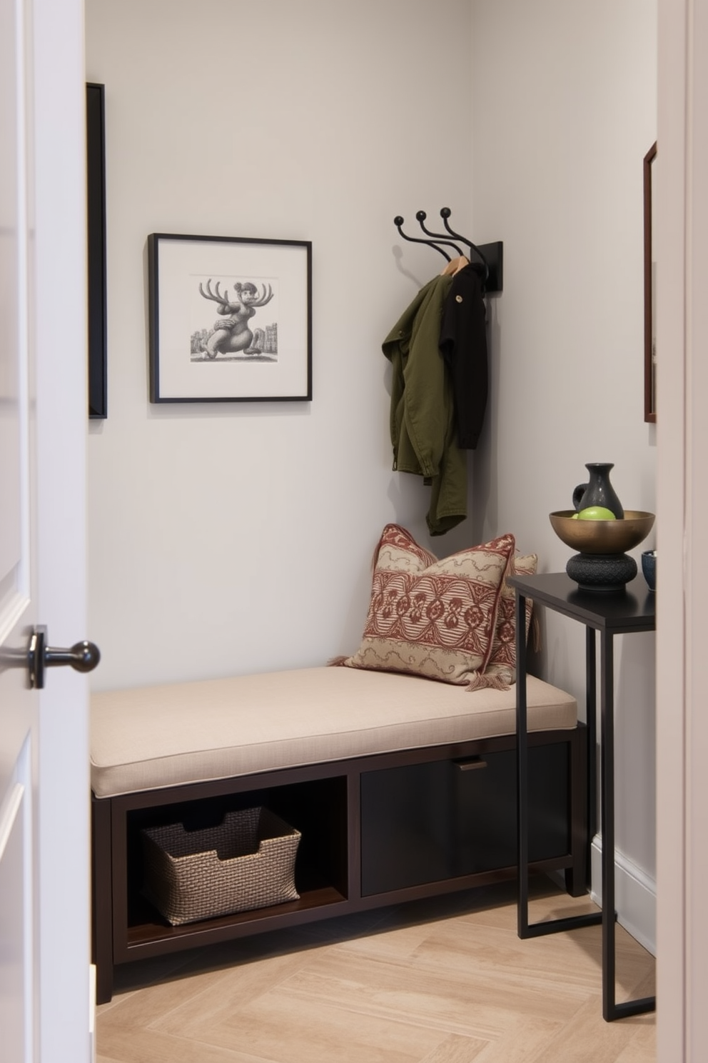 A narrow foyer features a sleek bench that provides both seating and storage. The walls are adorned with subtle artwork, and a stylish coat rack stands nearby, creating a welcoming entrance. The bench is upholstered in a soft fabric, complemented by decorative throw pillows for added comfort. A narrow console table against the wall holds a small lamp and a decorative bowl, enhancing the foyer's functionality and charm.