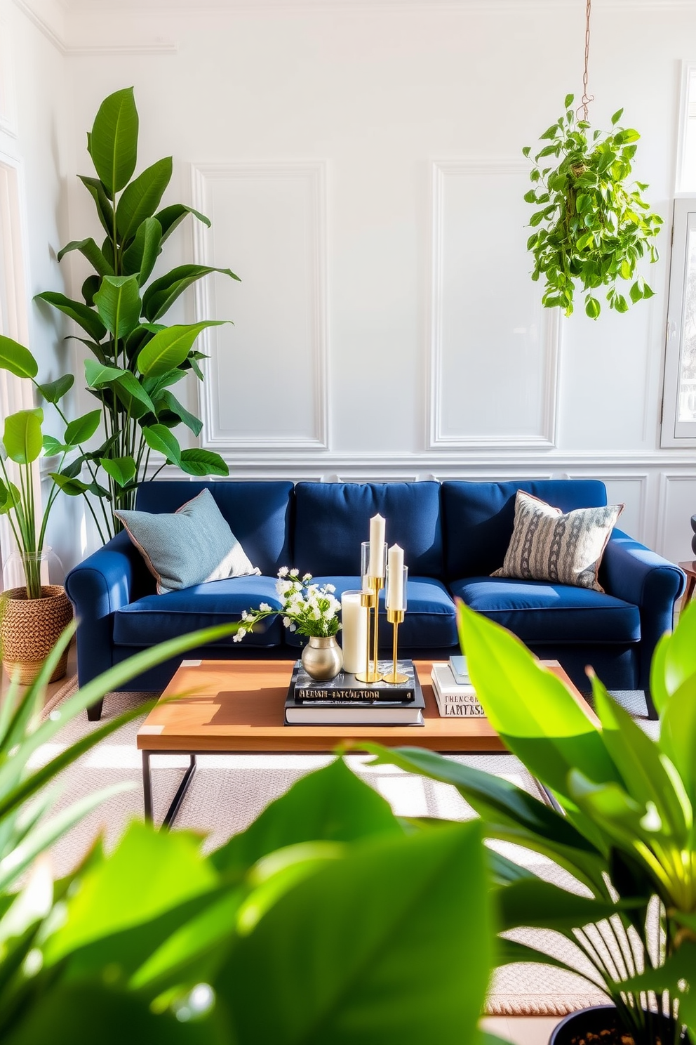 A navy blue sofa is elegantly positioned in a cozy living room, surrounded by lush green plants that add a vibrant touch. The walls are painted in a soft white hue, creating a bright contrast with the deep blue of the couch. A stylish coffee table sits in front of the sofa, adorned with decorative books and a chic candle arrangement. Natural light streams in through large windows, enhancing the inviting atmosphere of the space.