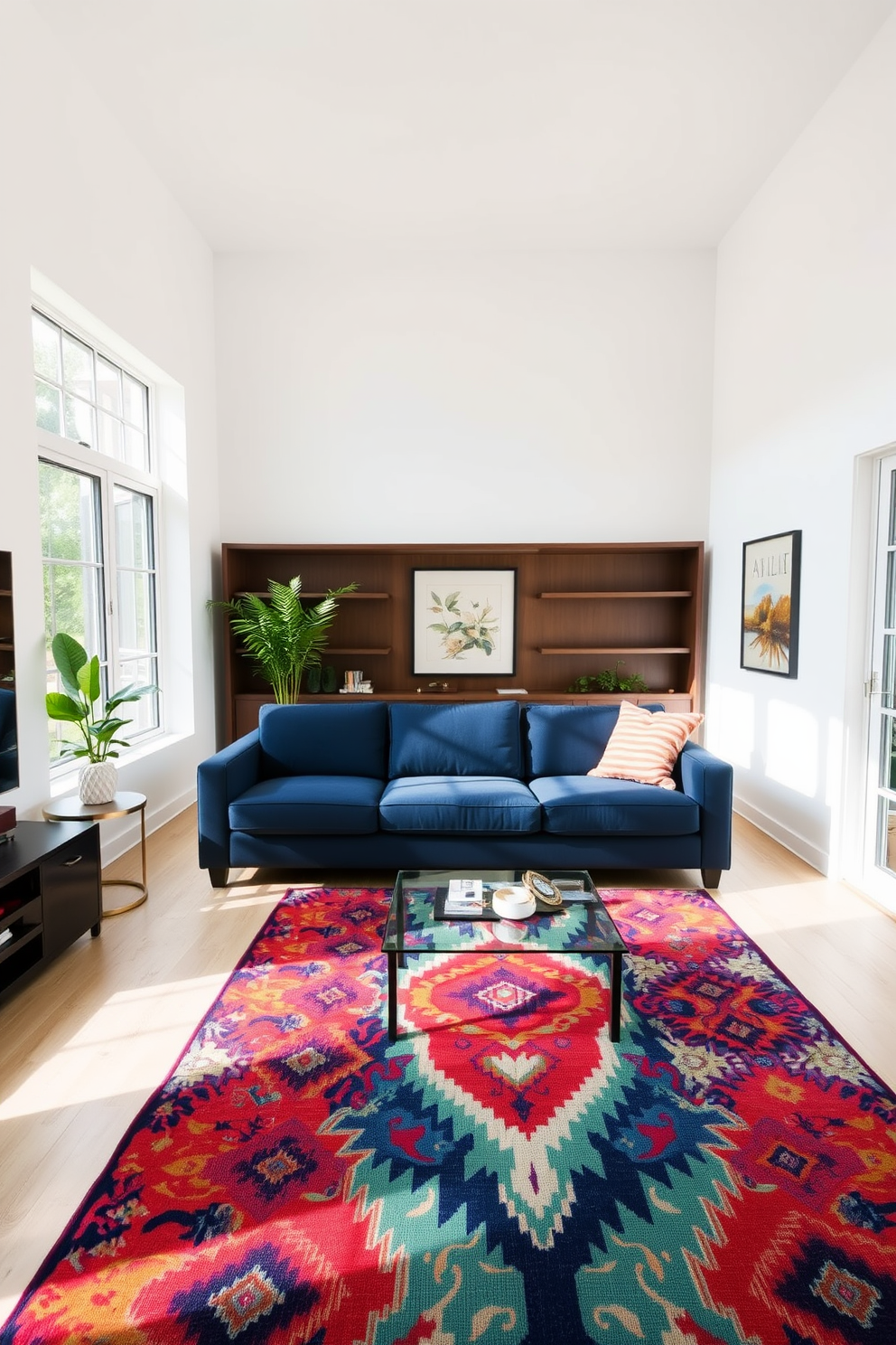 A navy sofa is the centerpiece of a modern living room, complemented by a colorful patterned rug that adds vibrancy to the space. The walls are painted in a soft white, and large windows allow natural light to illuminate the room, creating a warm and inviting atmosphere.