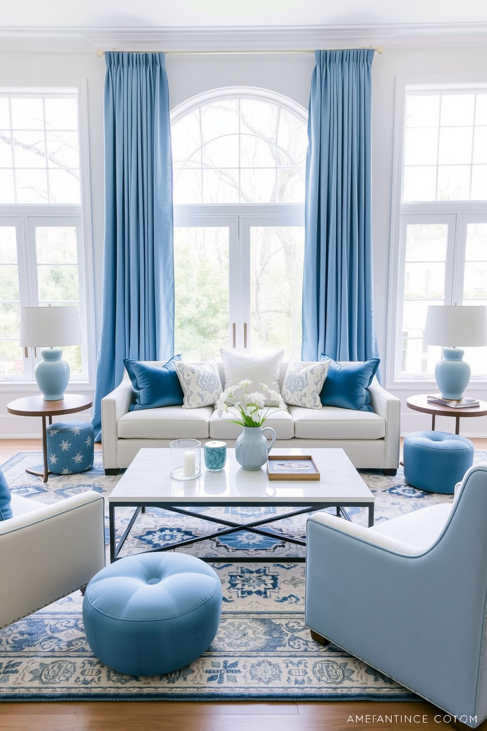 A serene living room featuring soft blue accents throughout the space. The walls are painted in a light neutral tone, complemented by a plush sofa adorned with blue and white throw pillows. A stylish coffee table sits in the center, surrounded by a mix of textured area rugs. Floor-to-ceiling curtains in a soft blue fabric frame the large windows, allowing natural light to filter in gently.