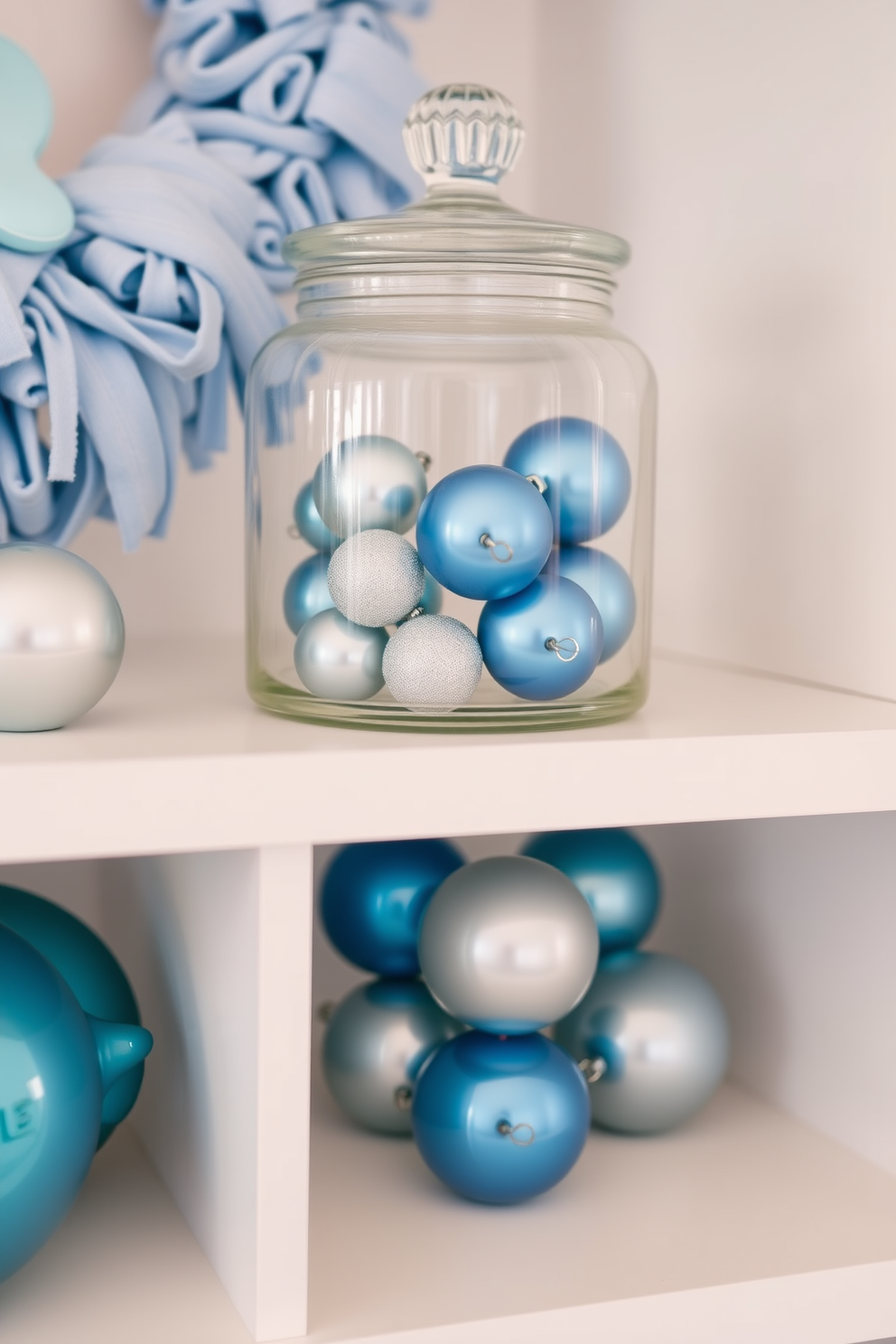 A charming nursery setup featuring a glass jar filled with blue and silver ornaments. The decorations are tastefully arranged on a soft white shelf, complementing the pastel color scheme of the room.