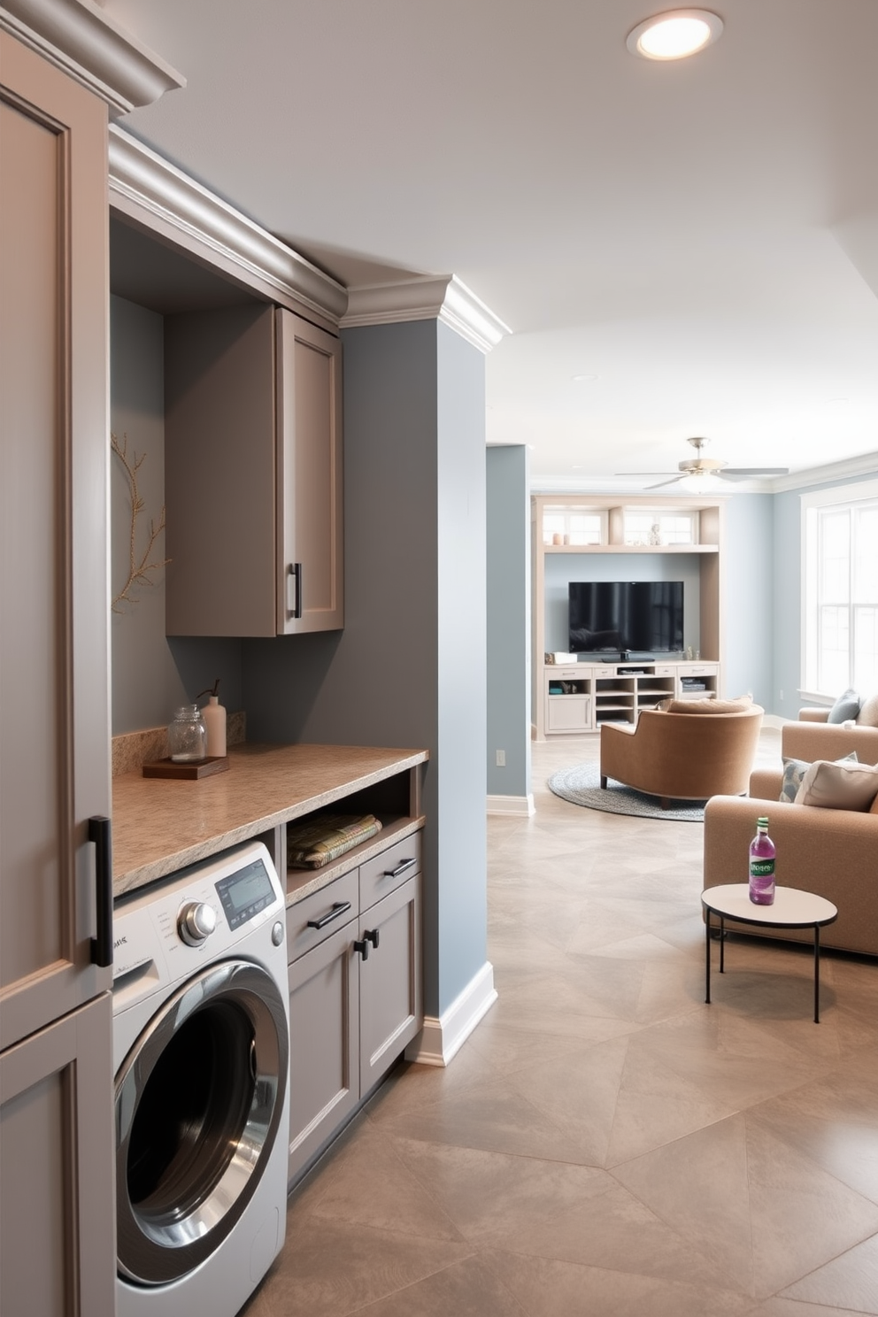 A functional laundry area features a spacious folding station made of light wood with ample storage underneath. The walls are painted in a soft gray, and the floor is adorned with durable vinyl tiles for easy cleaning. Open basement design ideas include a cozy lounge area with a sectional sofa and a coffee table. Large windows allow natural light to flood the space, creating an inviting atmosphere for relaxation and entertainment.