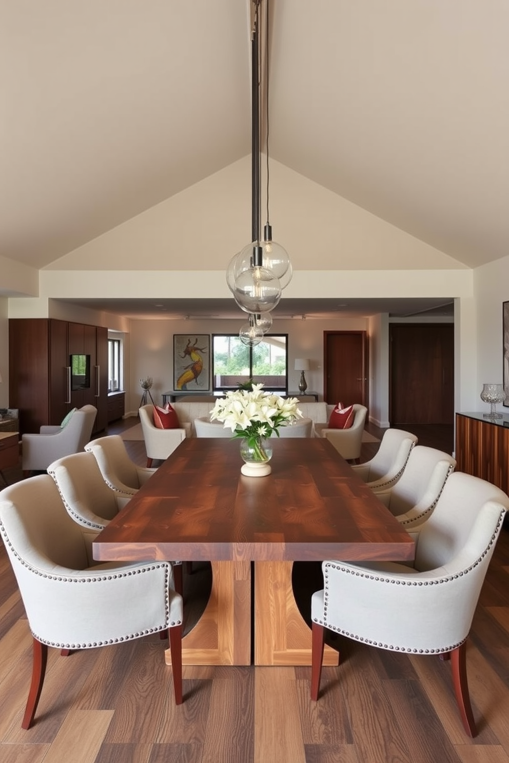 A stylish open floor plan dining room features a large wooden dining table surrounded by elegant upholstered chairs. Above the table, modern pendant lights hang gracefully, providing warm illumination and enhancing the room's inviting atmosphere.