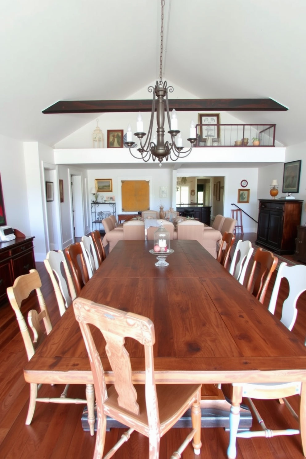 A spacious open floor plan dining room features a large reclaimed wood dining table surrounded by mismatched vintage chairs that add character and charm. The walls are adorned with eclectic artwork, and a vintage chandelier hangs above the table, casting a warm glow over the inviting space.