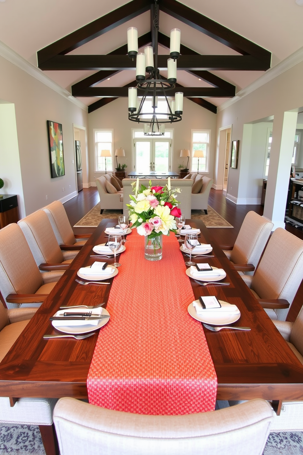 A stylish open floor plan dining room features a large wooden dining table surrounded by upholstered chairs in a neutral fabric. A textured table runner in a bold color runs down the center of the table, complemented by elegant place settings and a centerpiece of fresh flowers.