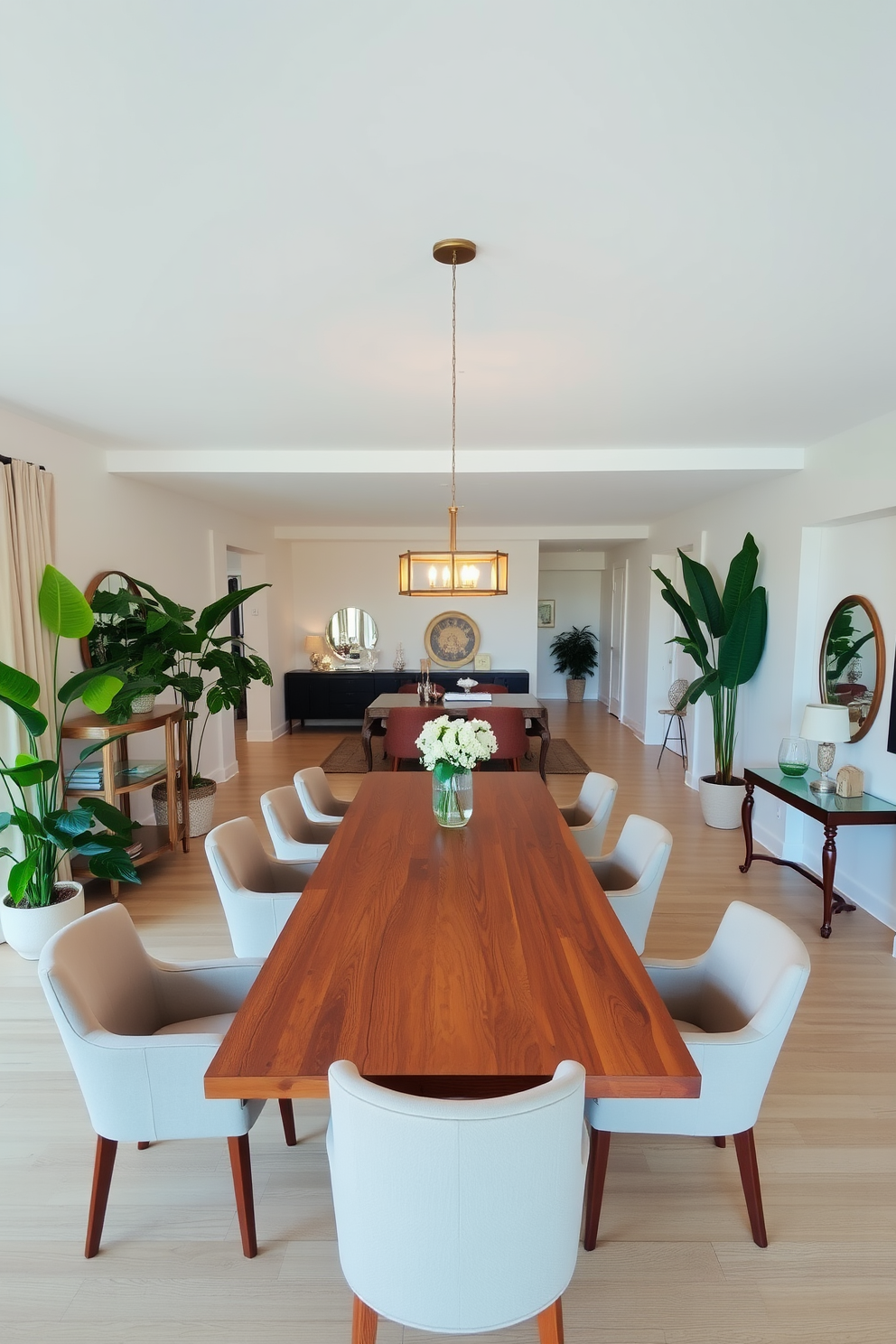 A spacious open floor plan dining room features a large wooden table with elegant white chairs around it. The walls are painted in a deep navy blue, contrasting beautifully with the light oak flooring and bright artwork hung on the walls. A stunning chandelier made of crystal hangs above the table, casting a warm glow over the space. Large windows allow natural light to flood in, accentuating the vibrant colors of the room and creating an inviting atmosphere.