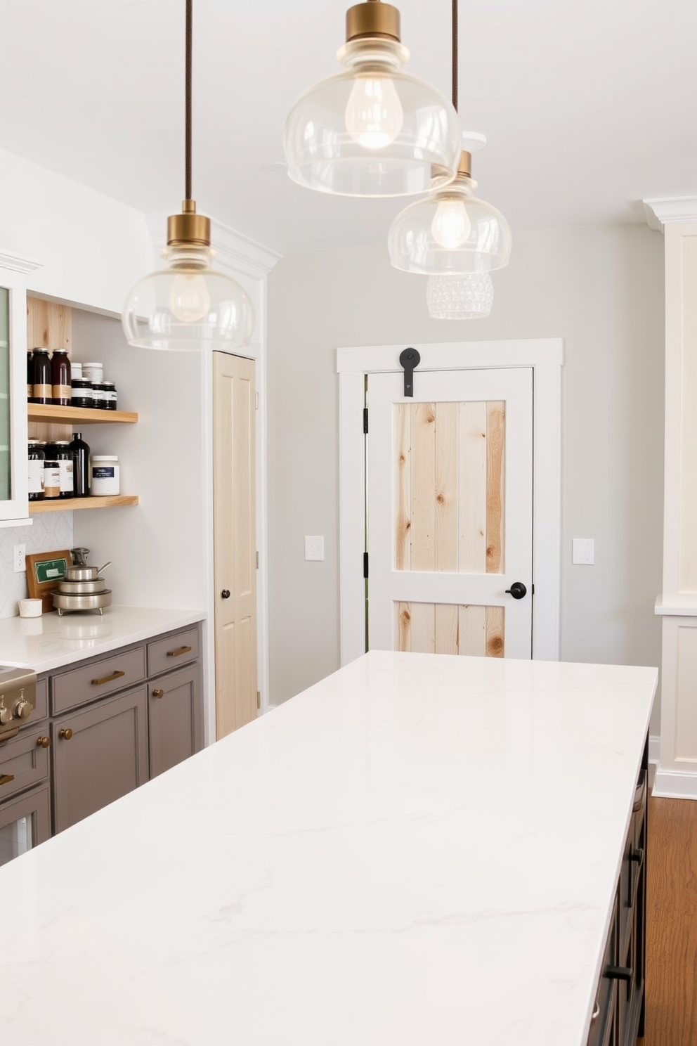 A spacious kitchen layout with ample counter space for food preparation. The countertops are made of sleek quartz with a bright white finish, complemented by elegant pendant lighting above. To the side, a well-organized pantry features open shelving made of reclaimed wood, displaying neatly arranged jars and containers. The pantry door is a classic barn-style door painted in a soft pastel color, adding a charming touch to the overall design.