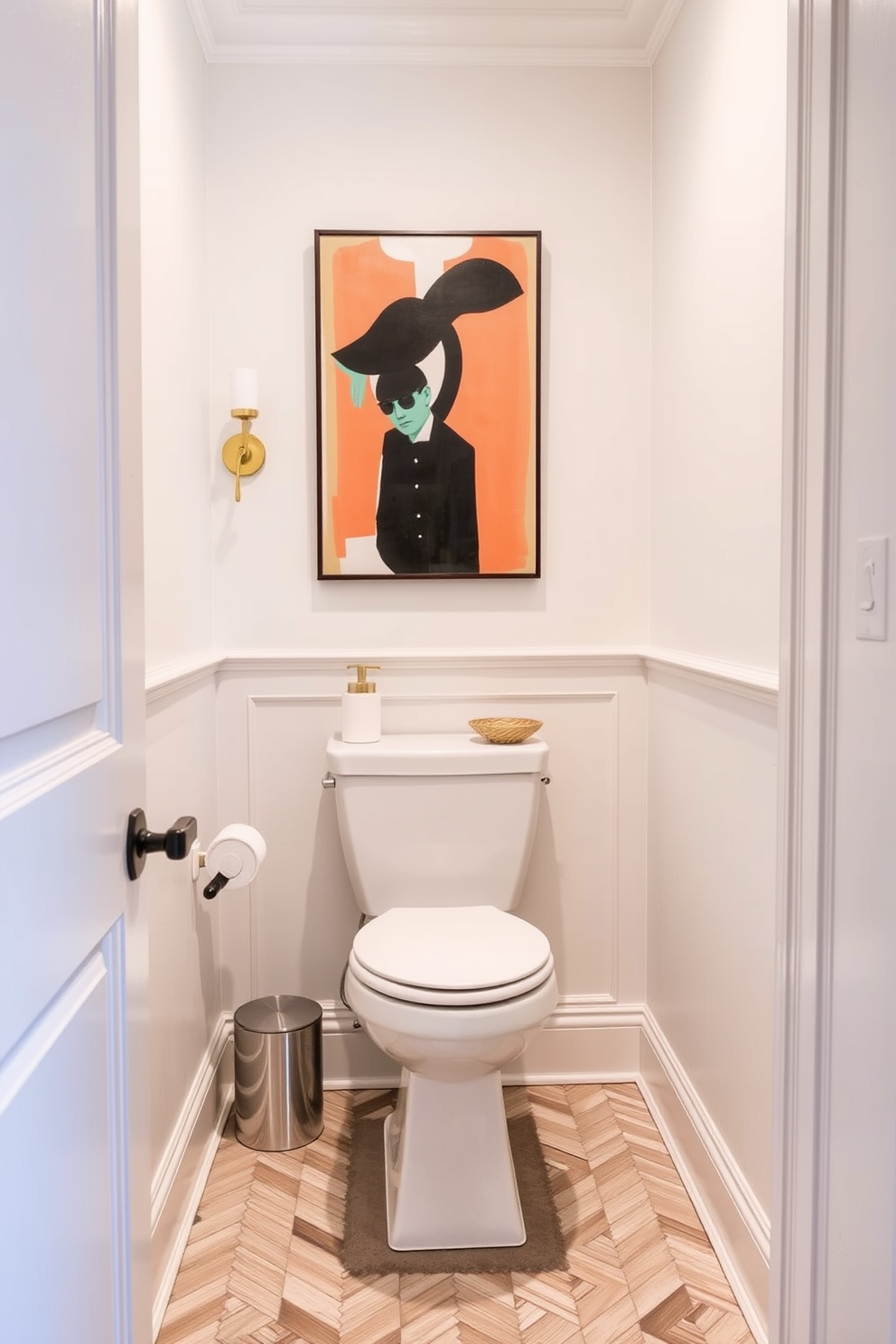 A chic powder room featuring a statement art piece above the toilet that serves as a focal point. The walls are adorned with a soft pastel hue, and the floor is laid with elegant herringbone tiles.