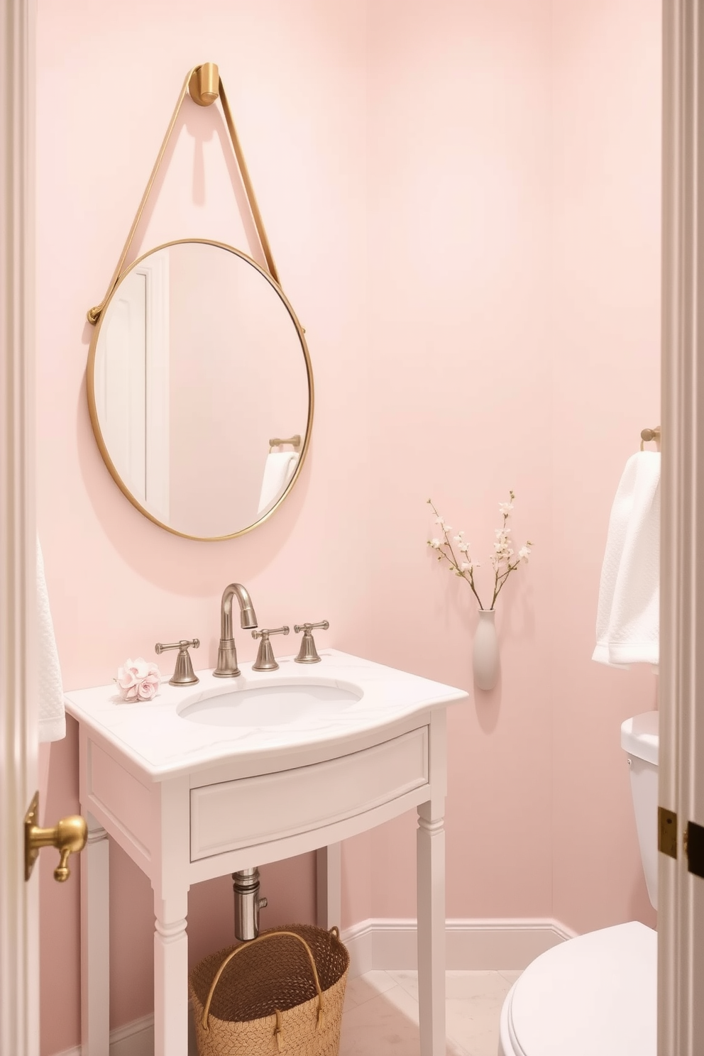 A serene powder room featuring soft pastel colors creates a calming atmosphere. The walls are painted in a light blush hue, complemented by a delicate white vanity with a polished marble top. A round mirror with a thin gold frame hangs above the sink, reflecting the gentle tones of the space. Subtle floral accents in the decor and a plush white towel draped elegantly add to the tranquil ambiance.