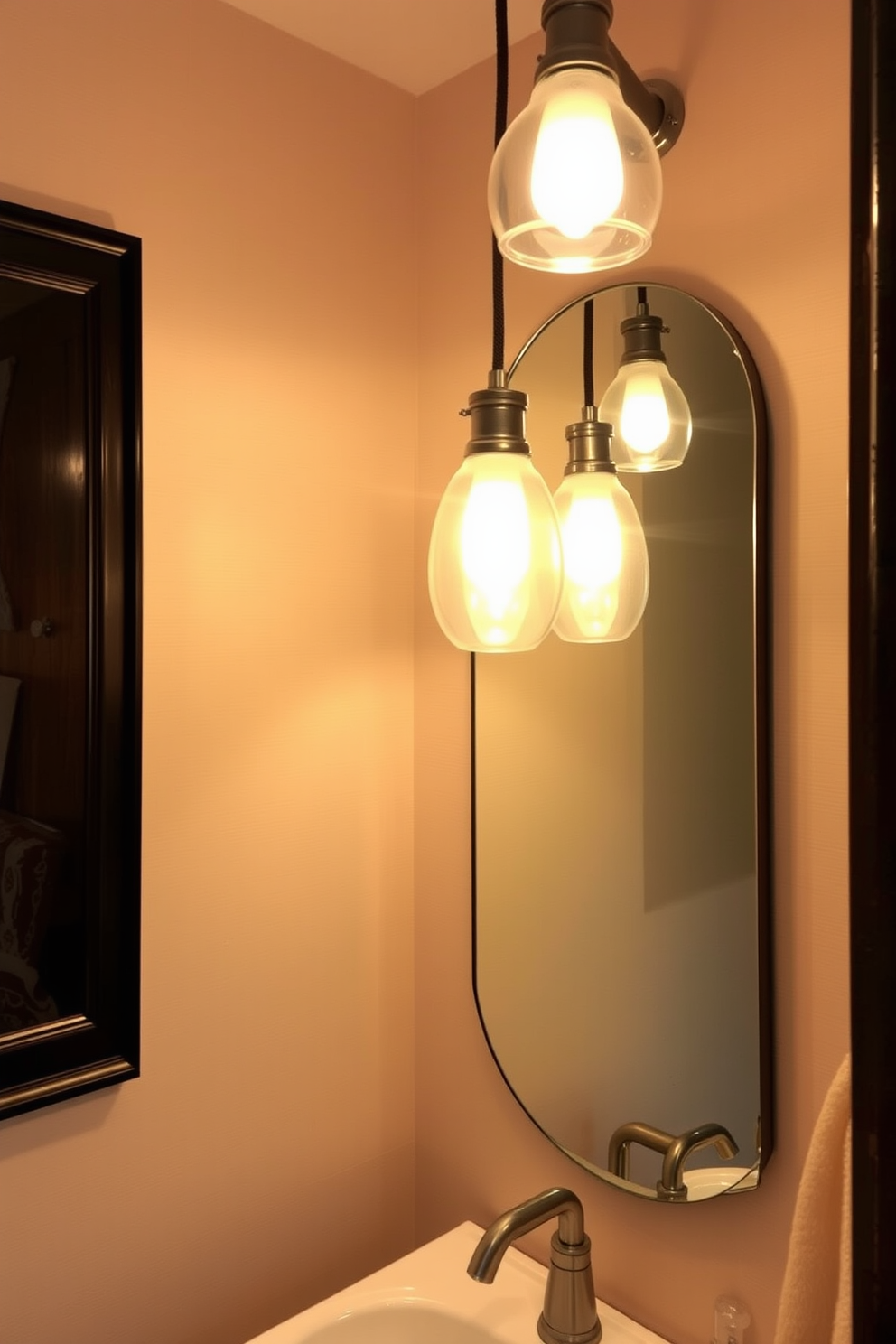 A cozy powder room featuring soft pendant lights that cast a warm glow throughout the space. The walls are adorned with subtle wallpaper, and a stylish mirror reflects the inviting light from the fixtures above.