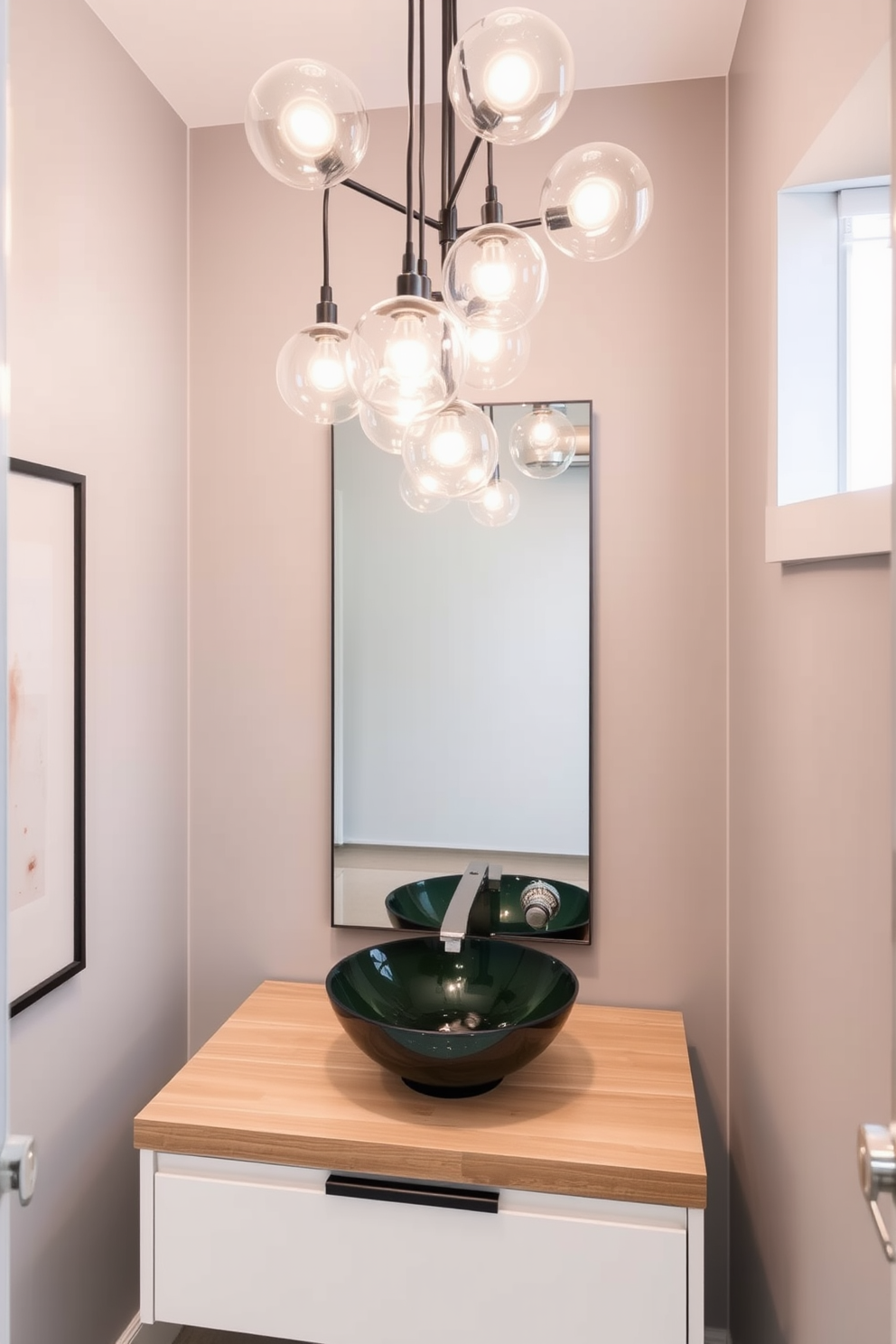 A contemporary powder room features sleek glass globes suspended from the ceiling, casting a warm and inviting glow. The walls are adorned with a soft gray hue, complementing the modern fixtures and minimalist decor. The glass globes are arranged in an artistic cluster, creating a focal point above a stylish vanity. Below, a chic vessel sink rests on a floating wooden countertop, enhancing the room's elegant aesthetic.