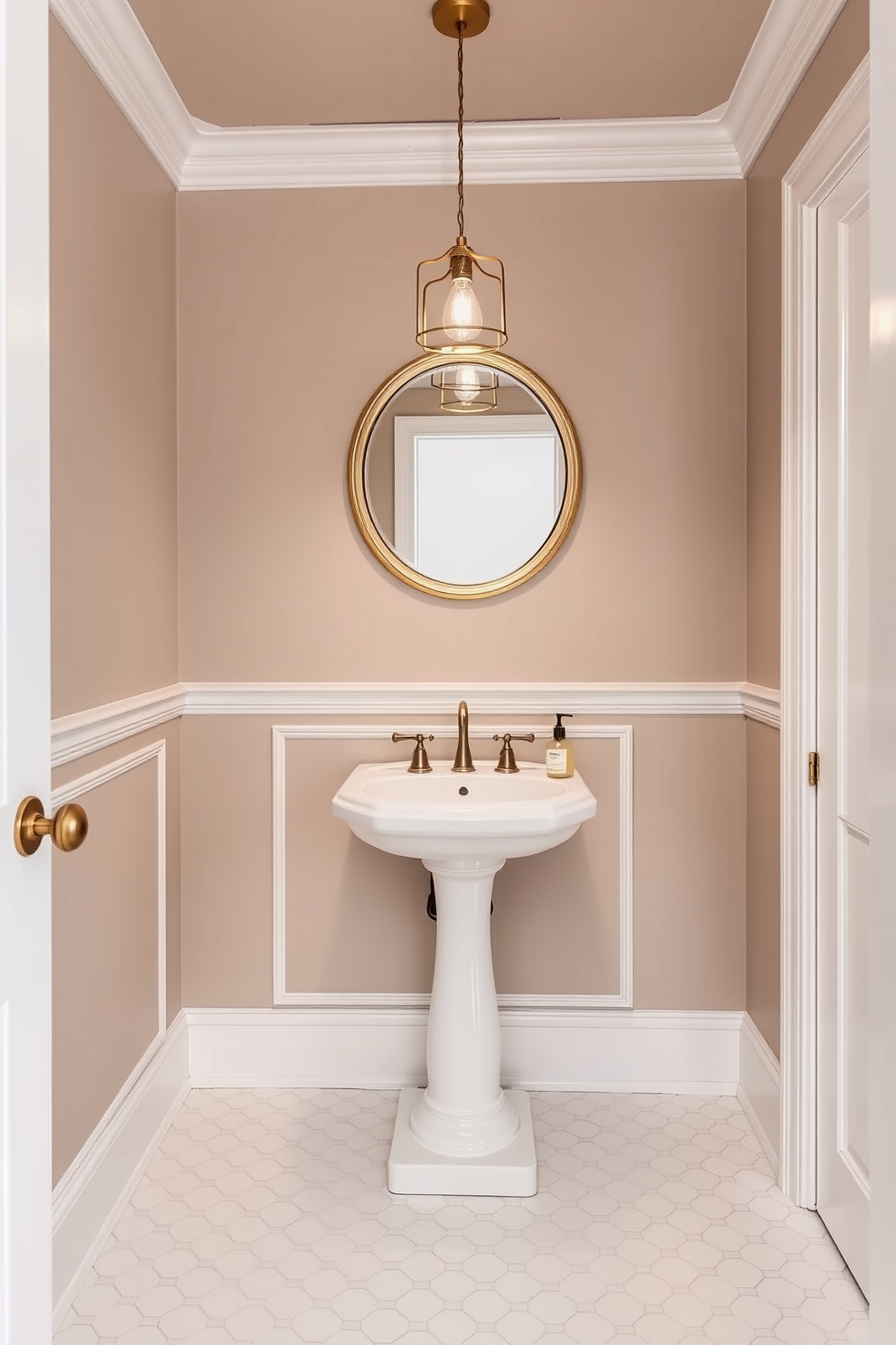 A powder room adorned in subtle taupe creates a serene and inviting atmosphere. The walls are painted in a soft taupe hue, complemented by elegant white trim and a stylish pedestal sink. The floor features classic white hexagonal tiles that add a touch of sophistication. A round mirror with a delicate gold frame hangs above the sink, reflecting the warm light from a chic pendant fixture.