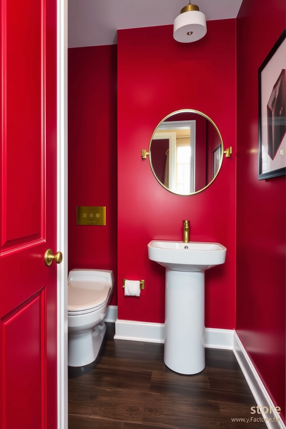 A bold powder room featuring striking red walls that create a dramatic atmosphere. The space is accented with sleek white fixtures and gold hardware for a touch of elegance. A modern pedestal sink stands against the vibrant backdrop, complemented by a chic round mirror with a gold frame. The flooring consists of dark wood planks that add warmth and sophistication to the overall design.