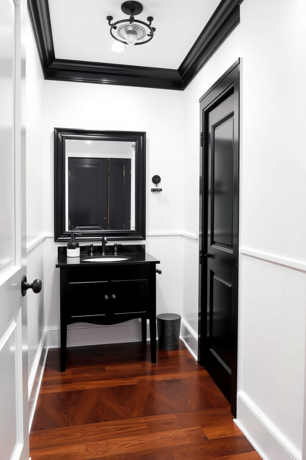 A classic powder room featuring crisp white walls that create a bright and airy atmosphere. Dark accents, such as a sleek black vanity and ornate fixtures, add a touch of elegance and sophistication to the space. The flooring consists of rich dark hardwood that contrasts beautifully with the light walls. A large framed mirror with a black border hangs above the vanity, reflecting the stylish decor and enhancing the room's depth.