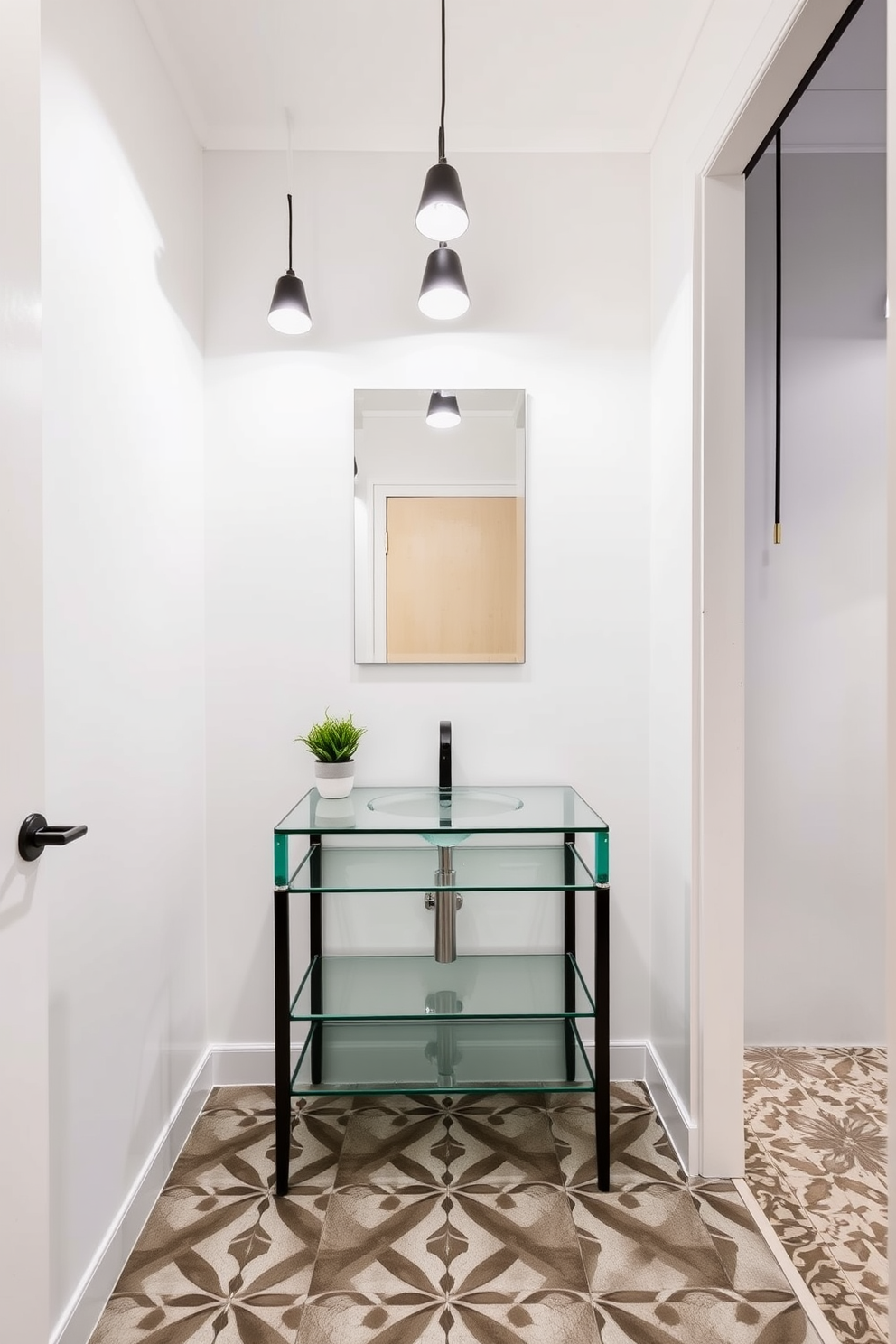 A contemporary glass vanity is set against a backdrop of sleek white walls. Bold lighting fixtures hang above, casting a warm glow and accentuating the elegant design of the space. The floor is adorned with geometric patterned tiles that add a touch of modern flair. A minimalist mirror reflects the stylish elements, while a small potted plant brings a hint of nature to the powder room.