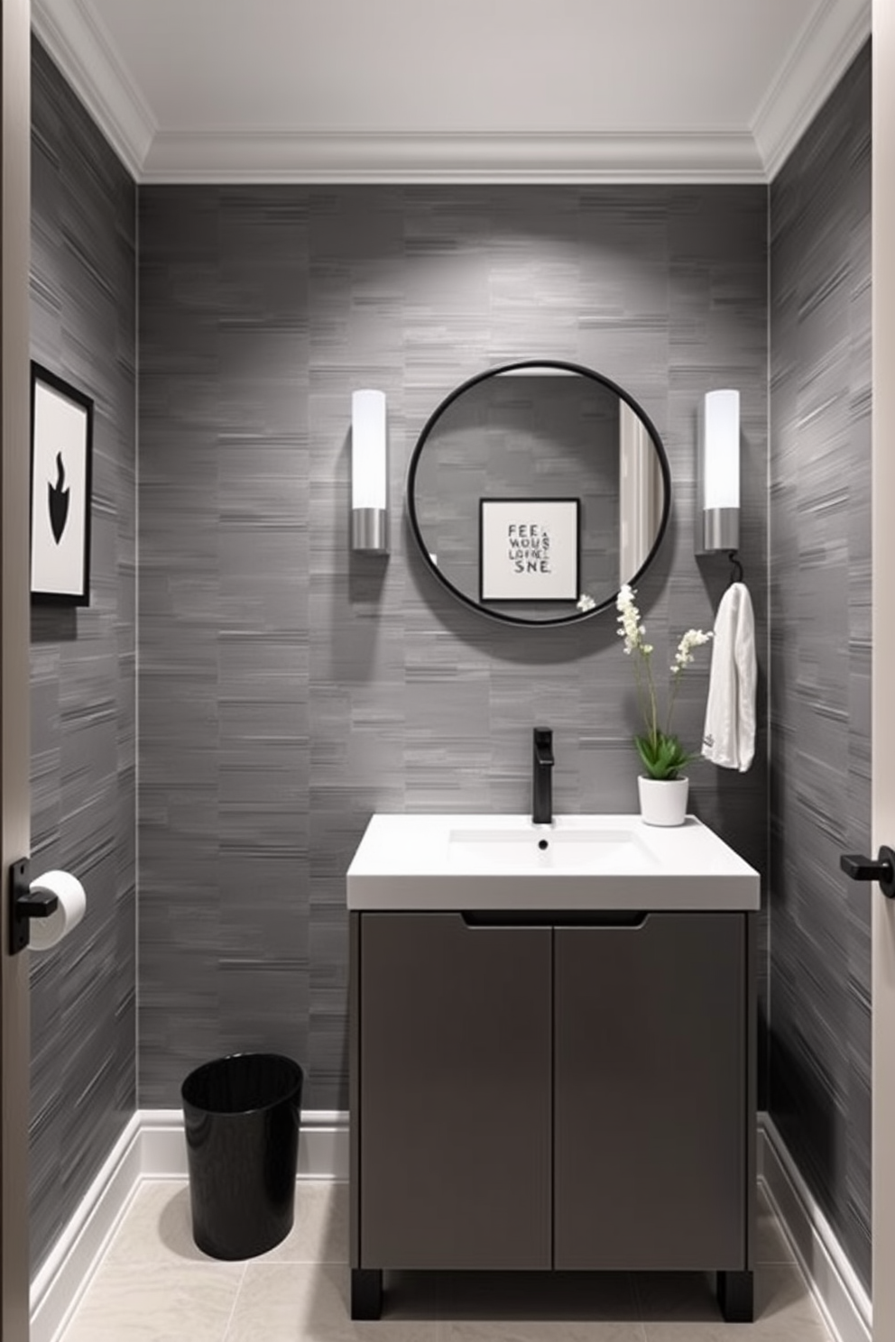 A chic powder room featuring a monochromatic color scheme that emphasizes simplicity and elegance. The walls are adorned with textured wallpaper in varying shades of gray, complemented by a sleek, minimalist vanity in a matching hue. The space includes a round mirror with a thin black frame, enhancing the clean lines of the design. Decorative elements such as a simple black and white artwork and a small potted plant add subtle sophistication to the overall aesthetic.