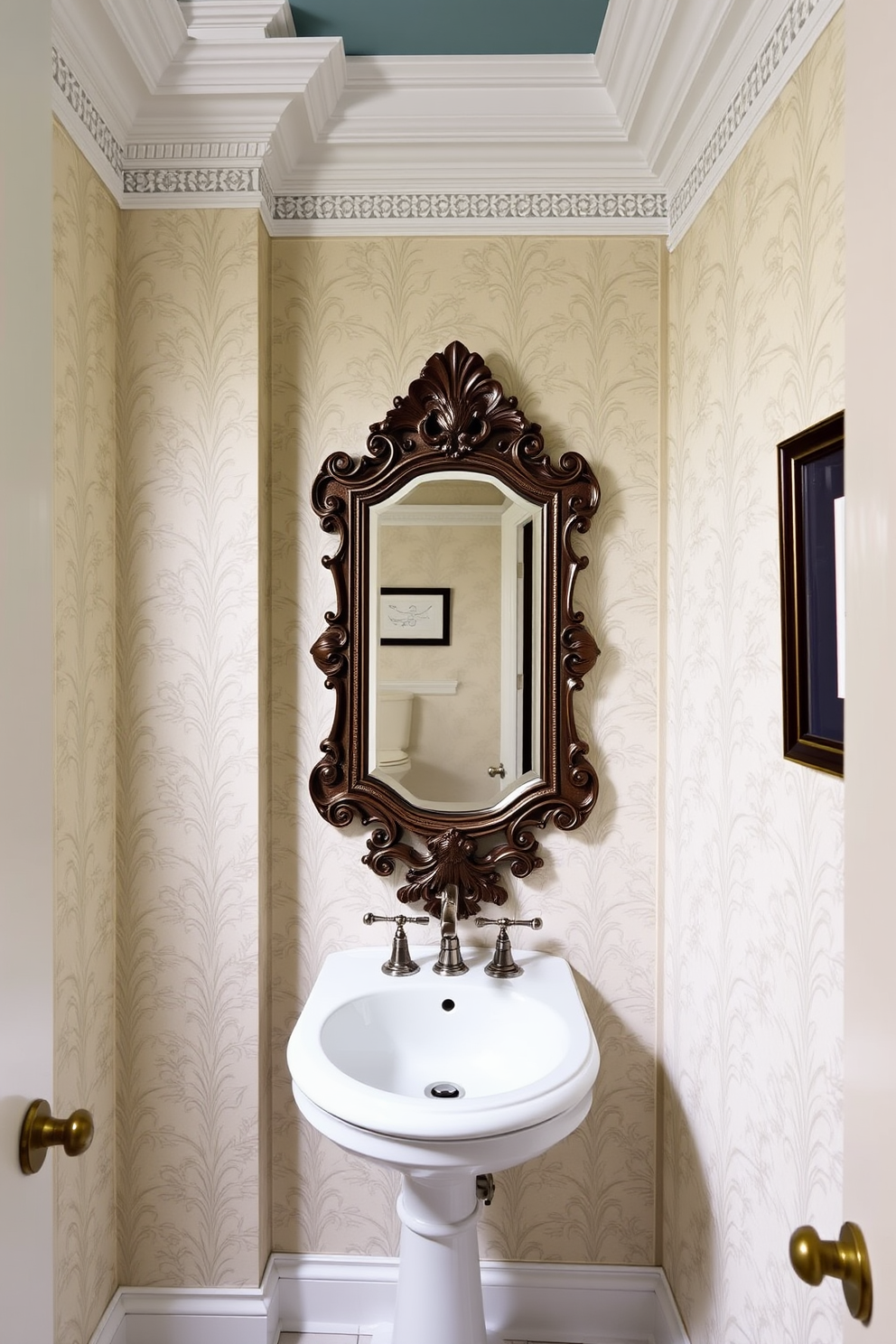 A stylish powder room featuring intricate crown molding that adds architectural interest to the space. The walls are adorned with elegant wallpaper showcasing a subtle floral pattern, complemented by a statement mirror with an ornate frame.