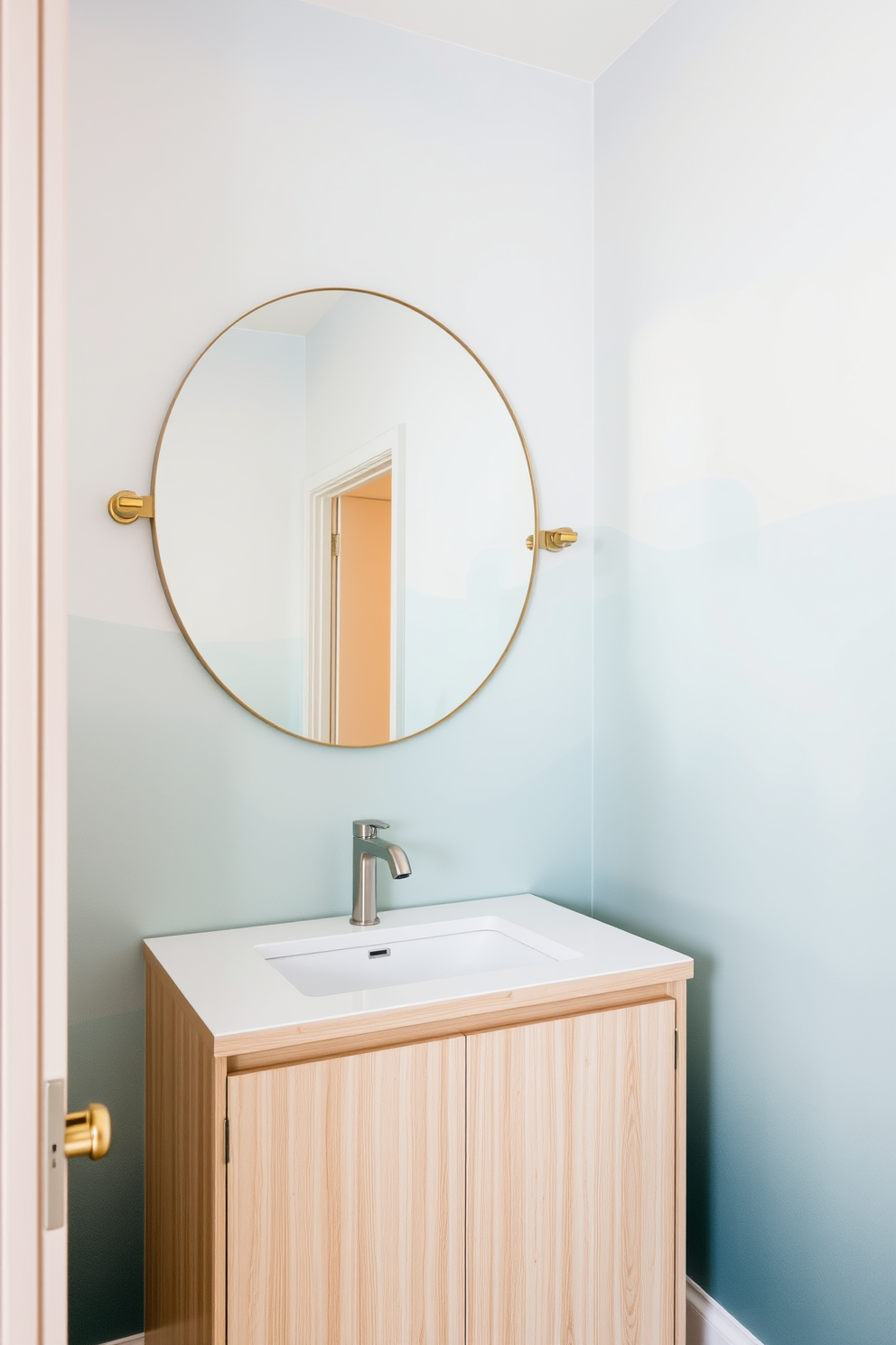 A serene powder room featuring tonal gradients that create a soothing atmosphere. The walls are adorned with wallpaper showcasing a subtle blend of soft blues and greens, enhancing the tranquility of the space. The vanity is sleek and modern, crafted from light wood with a minimalist design. Above it, a large round mirror reflects the calming colors, while delicate gold accents add a touch of elegance.