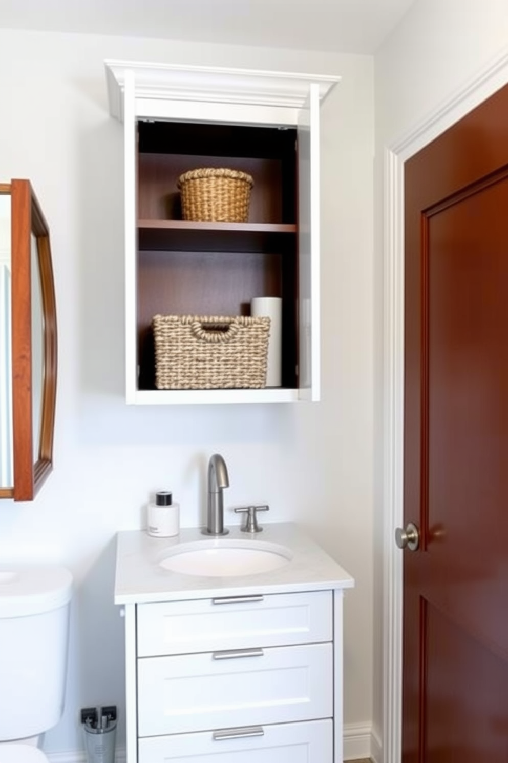 Functional storage solutions for small items in a quarter bathroom. The space features a sleek wall-mounted cabinet with open shelving for easy access to essentials, while a compact vanity with drawers maximizes storage without sacrificing style. The walls are painted in a light, airy color to enhance the sense of space. Decorative baskets are placed on the shelves, adding texture and organization to the room.