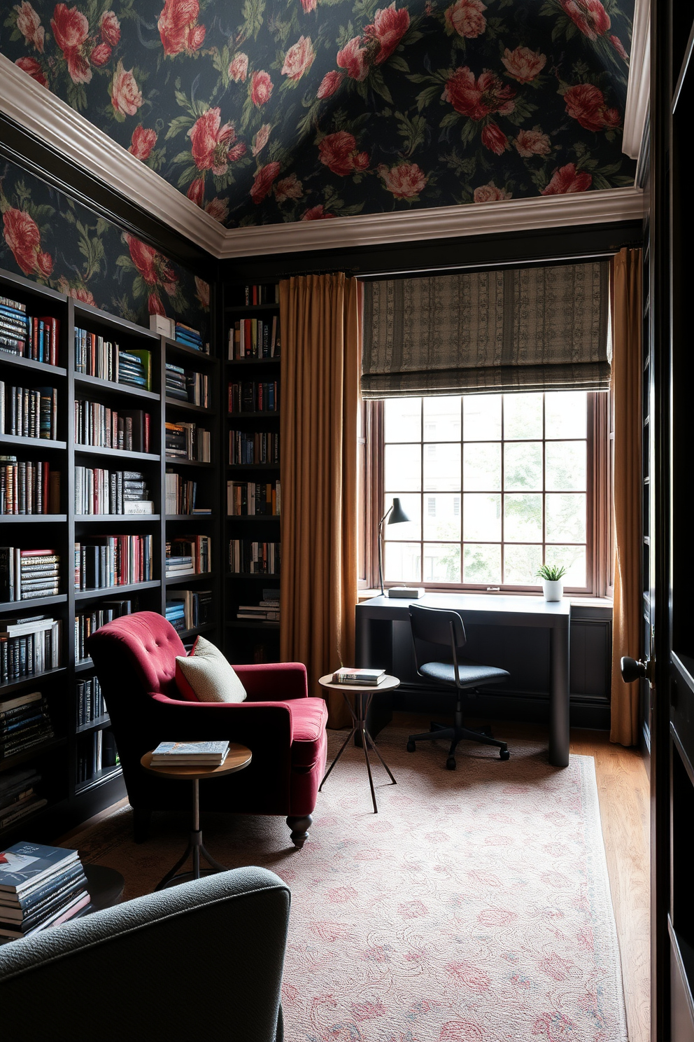 A cozy reading room featuring an accent wall adorned with bold floral wallpaper. The space includes a plush armchair in a rich velvet fabric positioned beside a small wooden side table stacked with books. The home library showcases floor-to-ceiling bookshelves filled with a curated collection of literature. A sleek, modern desk sits in front of a large window, providing ample natural light for reading and studying.