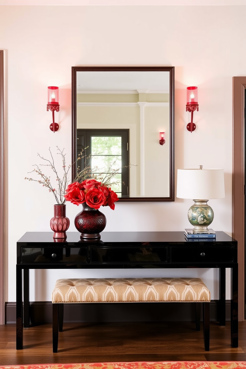 A cozy reading nook features a plush red accent chair positioned near a large window. Soft natural light filters through sheer curtains, illuminating a small side table stacked with books and a warm throw draped over the chair. The foyer design showcases a bold red accent wall that creates a striking first impression. A stylish console table is adorned with decorative objects and a mirror, while a chic area rug anchors the space beneath a stunning chandelier.