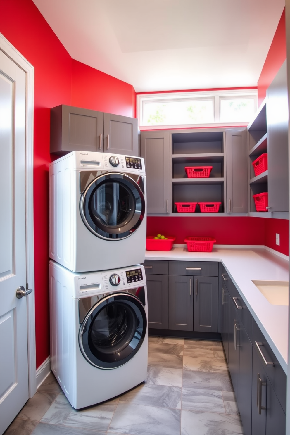 A modern laundry space featuring a bold red accent wall complemented by sleek gray cabinetry. The room includes a stylish front-loading washer and dryer stacked side by side, with a spacious countertop for folding clothes. Bright red baskets are neatly arranged on the shelves, adding a pop of color and organization. A large window allows natural light to illuminate the room, enhancing the vibrant atmosphere.