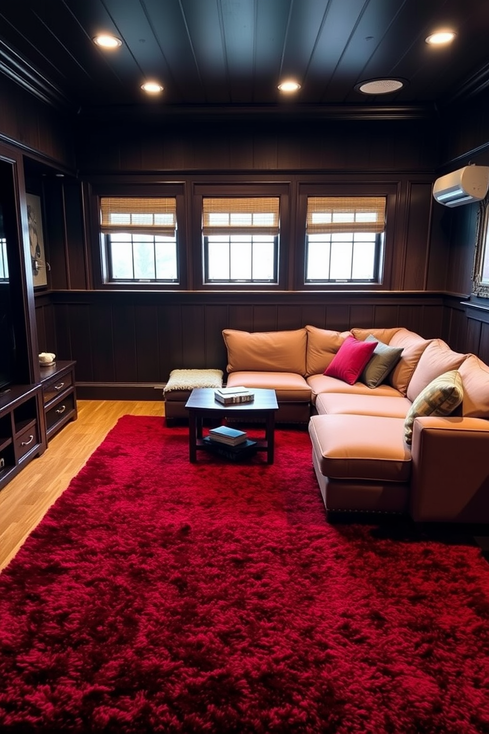 A cozy man cave featuring a plush red area rug that anchors the space. The walls are adorned with dark wood paneling, and a large sectional sofa in a complementary color offers ample seating for relaxation and entertainment.