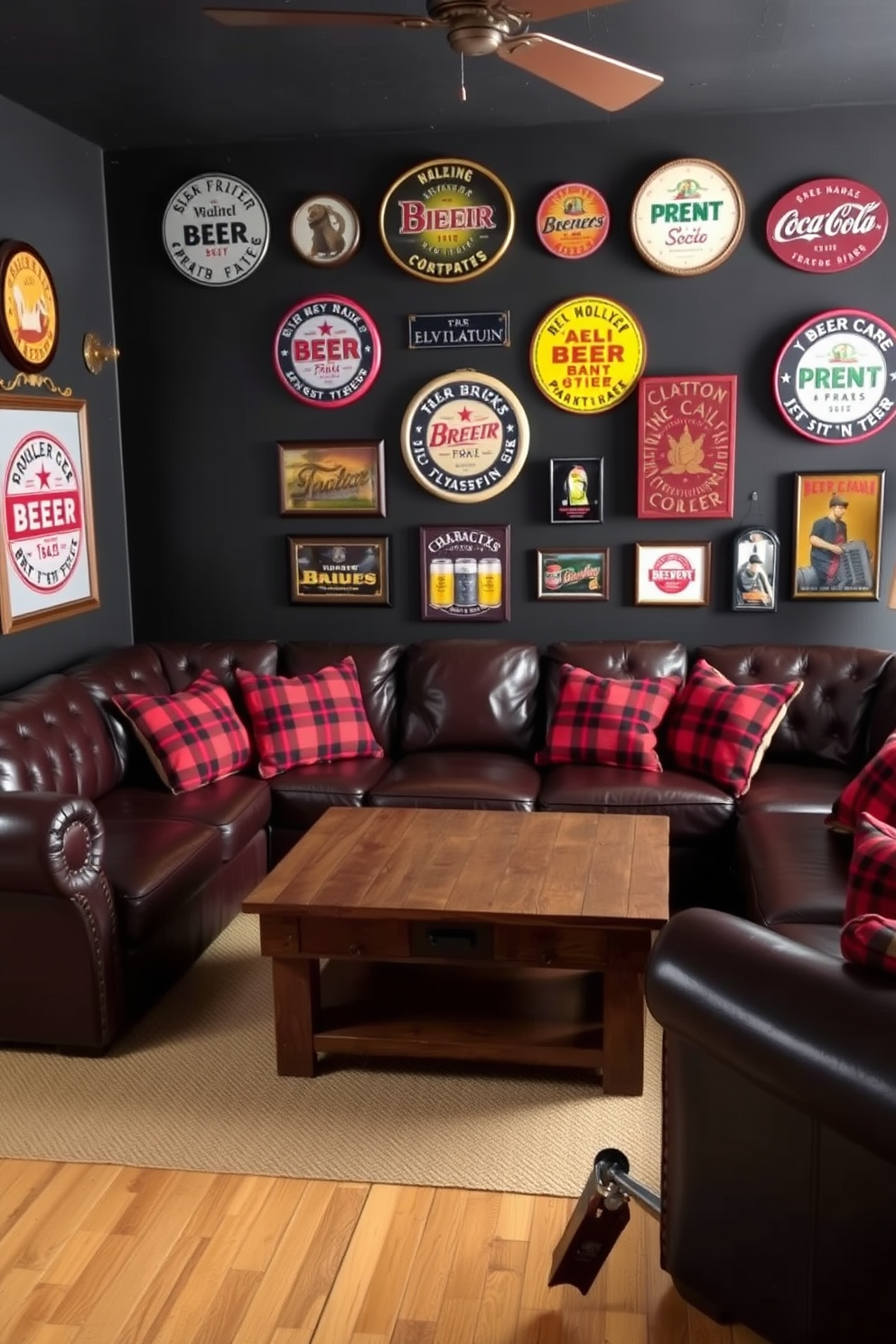 A cozy man cave featuring a deep leather sectional sofa adorned with classic red plaid throw pillows. The walls are painted a rich dark gray, and a rustic wooden coffee table sits in the center, surrounded by vintage beer signs and memorabilia.