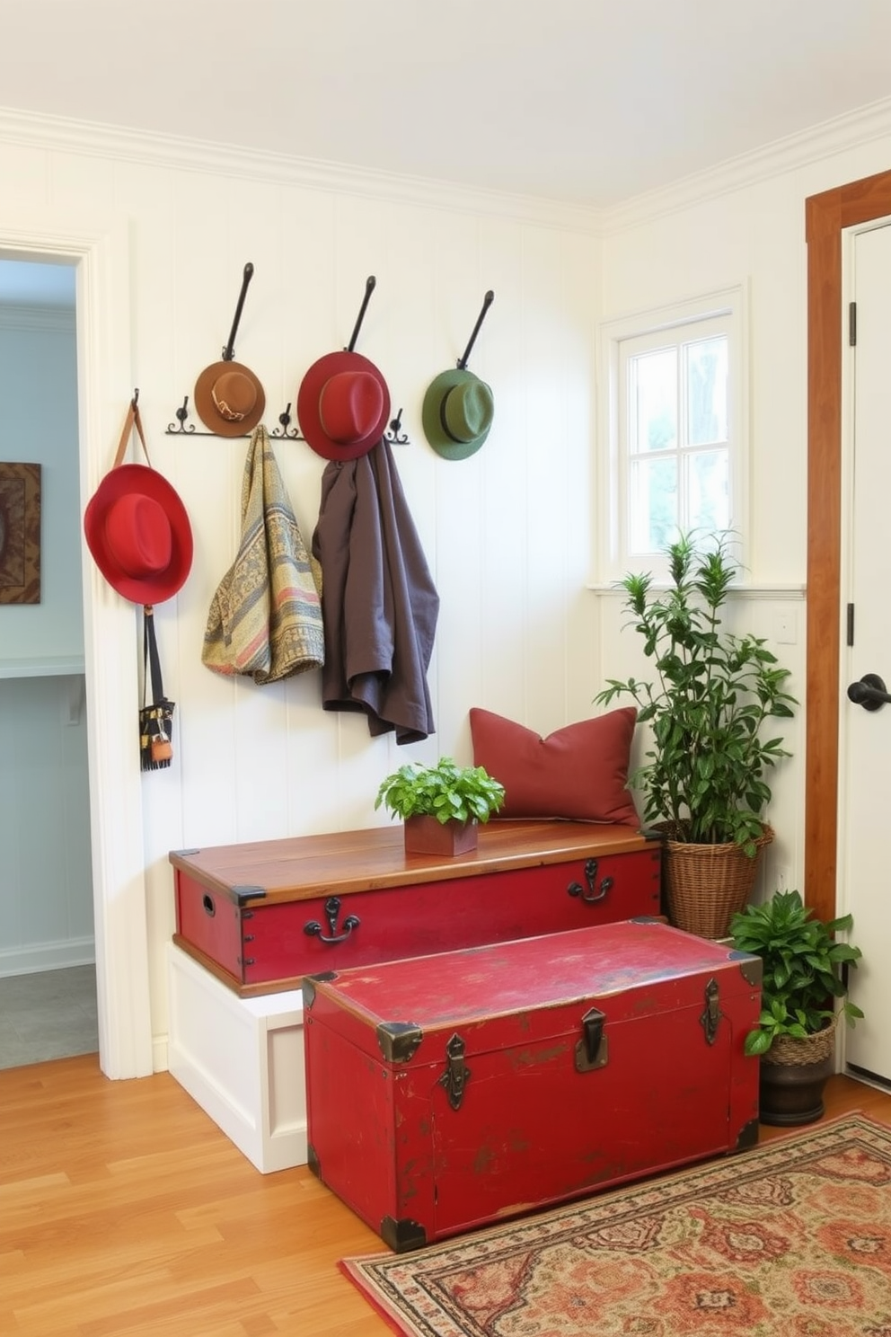 A vintage red trunk serves as a charming storage solution in the mudroom. The space features a rustic bench with hooks above for coats and hats, complemented by warm wooden accents. The mudroom is painted in a soft cream color, enhancing the vintage feel. A patterned rug adds texture, while potted plants bring a touch of nature indoors.