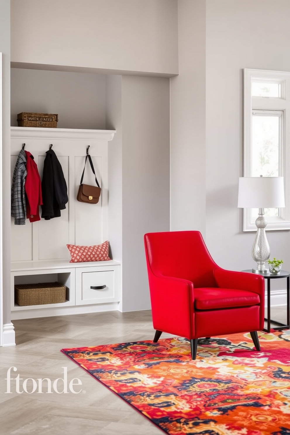 A striking red accent chair is positioned in the corner of a modern living room. It features sleek lines and plush upholstery, complemented by a contemporary side table and a vibrant area rug. The mudroom is designed with functionality in mind, showcasing built-in storage benches and hooks for coats. The walls are painted a soft gray, and the floor is finished with durable tiles that can withstand heavy foot traffic.