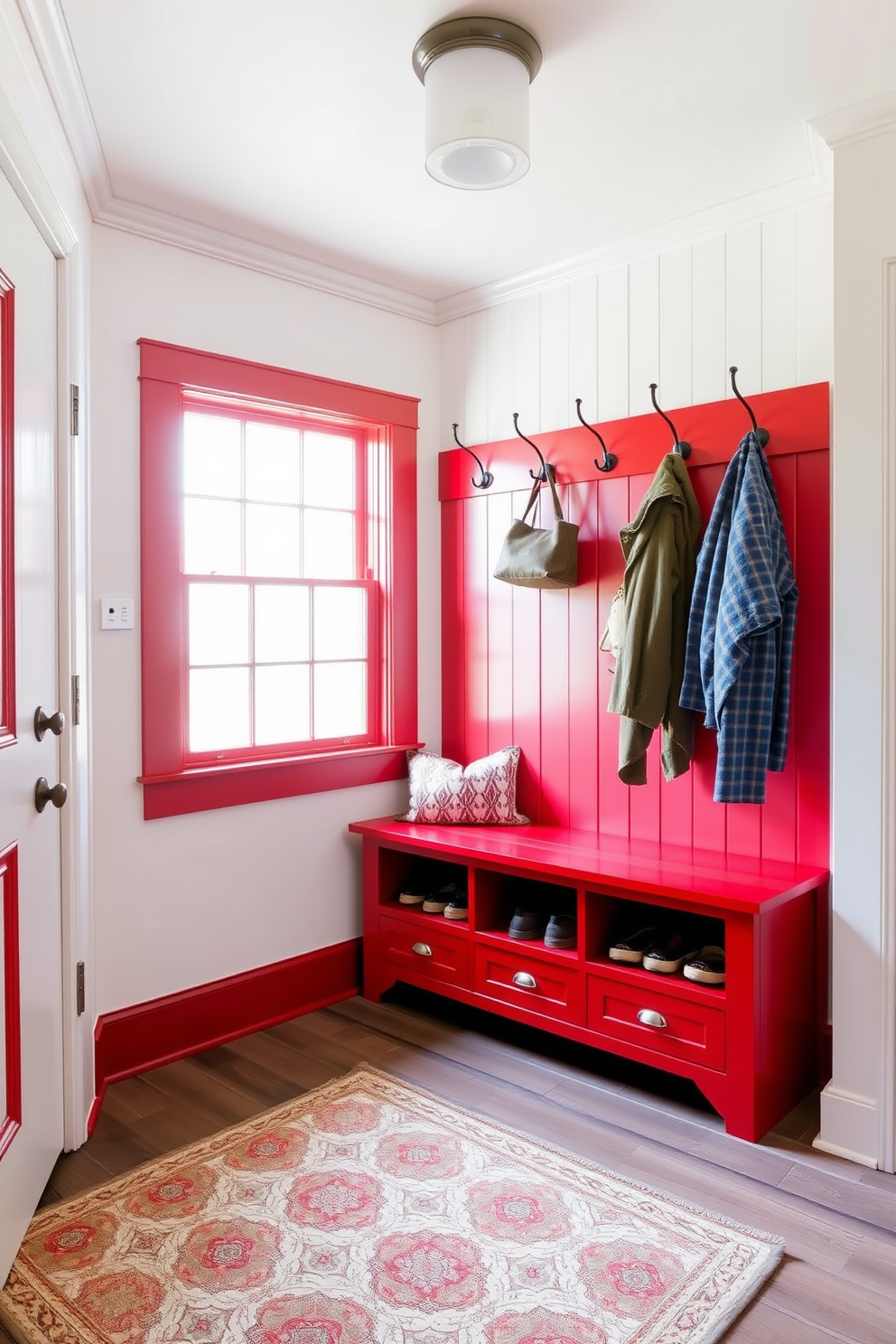 A vibrant red and white striped wallpaper adorns the walls, creating a bold and cheerful atmosphere. The stripes alternate in width, adding visual interest and depth to the space. The mudroom features a rustic wooden bench with built-in storage cubbies underneath. A series of hooks line the wall above for hanging coats and bags, complemented by a patterned rug that adds warmth and style.