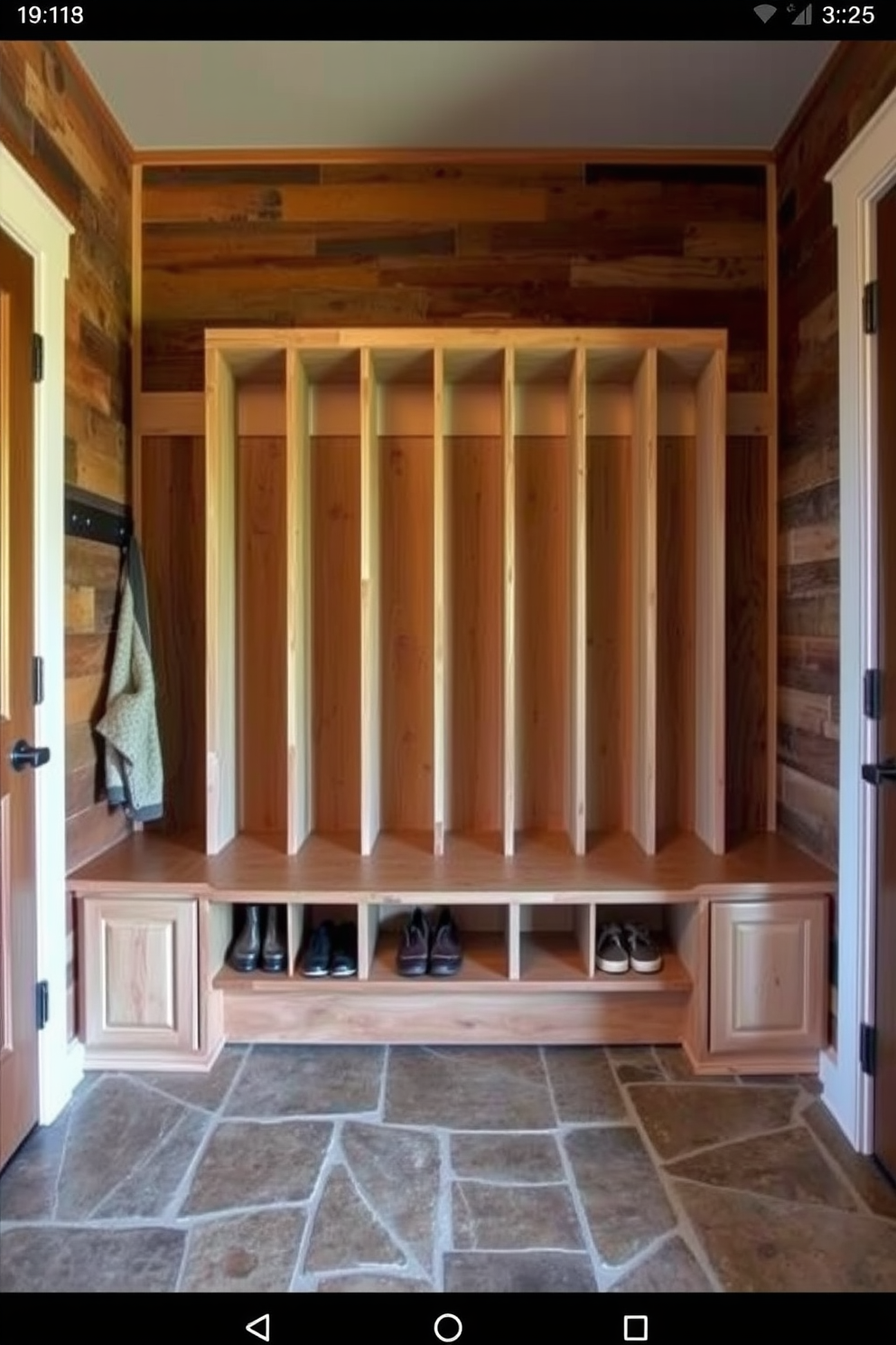 A colorful area rug is placed in the center of the room, featuring a vibrant pattern that adds warmth and character. Surrounding the rug, the mudroom is designed with rustic wooden benches and hooks for coats, creating a welcoming entryway. The walls are adorned with shiplap, painted in a soft white hue that complements the earthy tones of the decor. Natural light floods in through a large window, illuminating the space and enhancing the cozy atmosphere.