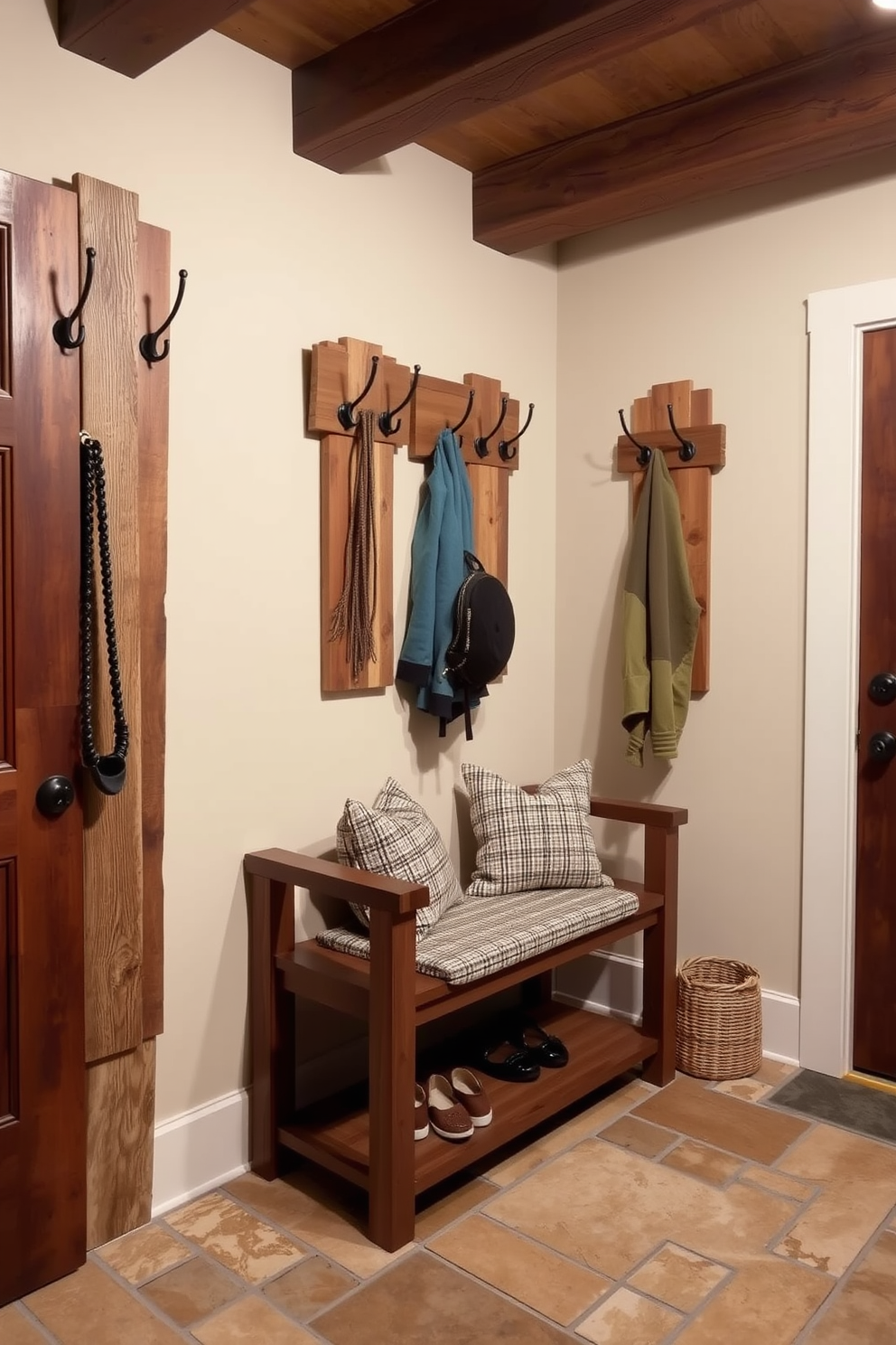 A charming rustic mudroom features decorative wall-mounted coat racks made of reclaimed wood. The space is accented with a natural stone floor and a cozy bench, inviting guests to relax while removing their shoes.