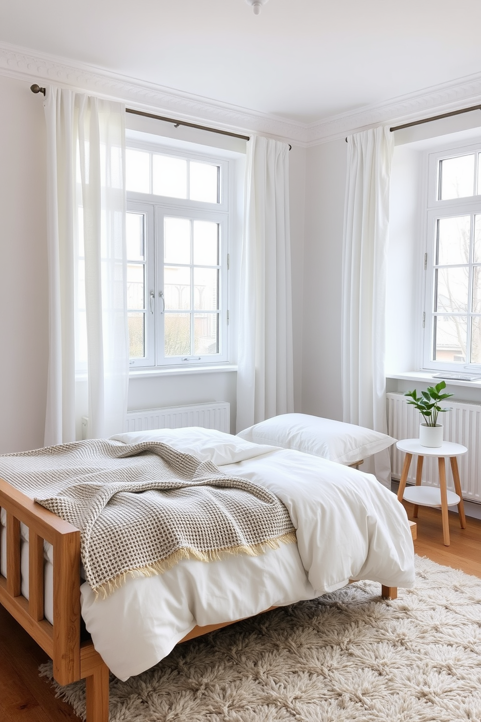 A serene Scandinavian bedroom featuring a neutral color palette that promotes a calming atmosphere. The walls are adorned with soft white paint, complemented by light wood accents and cozy textiles. A plush bed with a simple headboard is dressed in soft gray linens and a chunky knit throw. Natural light floods the space through large windows, illuminating a minimalist nightstand with a small potted plant.