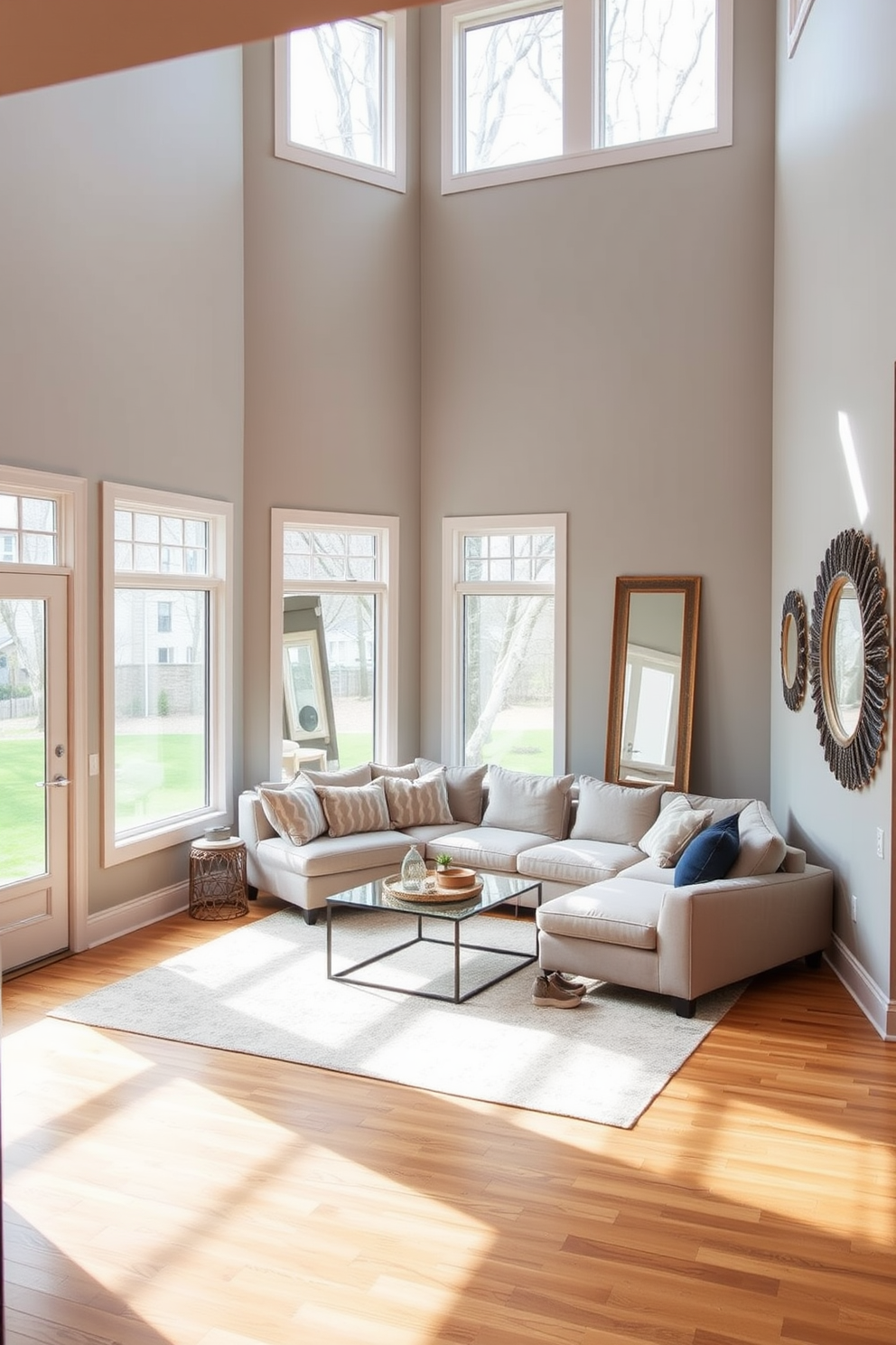 A cozy basement retreat featuring large windows that allow natural light to flood the space. The walls are painted in a light gray hue, and the floor is adorned with warm wooden planks for a welcoming feel. In one corner, a plush sectional sofa is arranged around a sleek coffee table, creating an inviting seating area. Decorative mirrors are strategically placed to reflect light and make the space feel larger and more open.