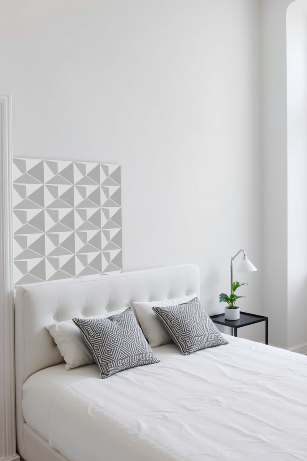 A serene bedroom featuring geometric patterns throughout. The walls are painted in a soft white, accented by a bold geometric wallpaper behind the bed. A low-profile bed with a tufted headboard sits against the wall, adorned with patterned throw pillows. A simple bedside table holds a sleek lamp and a small potted plant, adding a touch of greenery to the space.