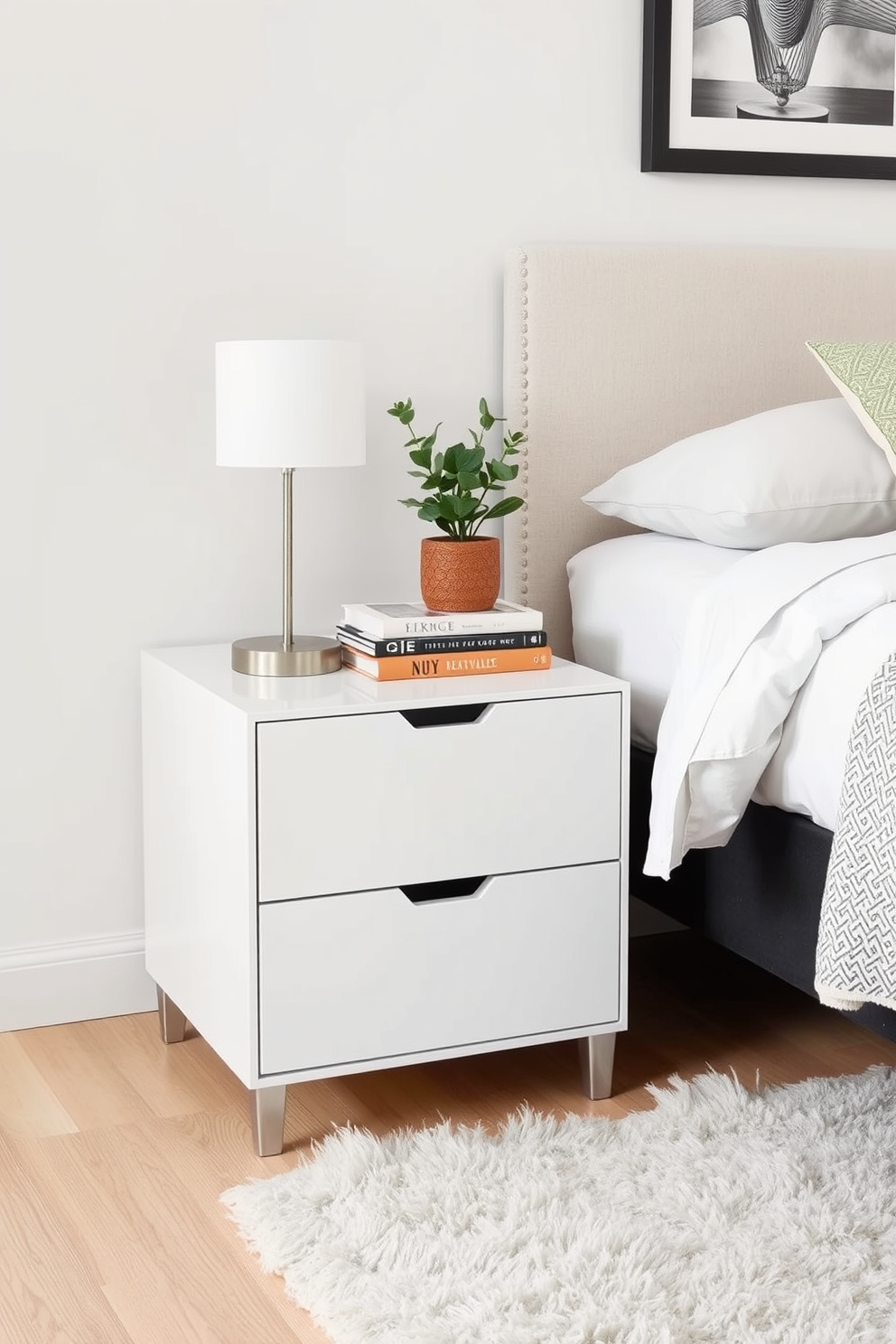 A functional nightstand with stylish decor sits beside a cozy bed. The nightstand features a sleek design with a small lamp, a stack of books, and a decorative plant on top. The bedroom is designed with soft neutral colors to create a calming atmosphere. A plush area rug lies beneath the bed, complementing the overall aesthetic of comfort and simplicity.