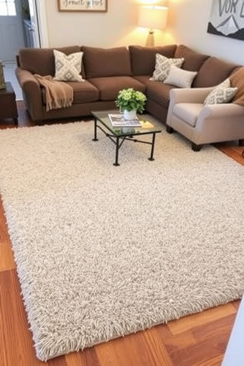 A cozy family room featuring a plush area rug that anchors the seating arrangement. The rug is layered over a hardwood floor, creating a warm and inviting atmosphere for family gatherings. The seating consists of a comfortable sectional sofa and accent chairs arranged around a coffee table. Soft throw pillows and a warm blanket add texture and comfort to the space.