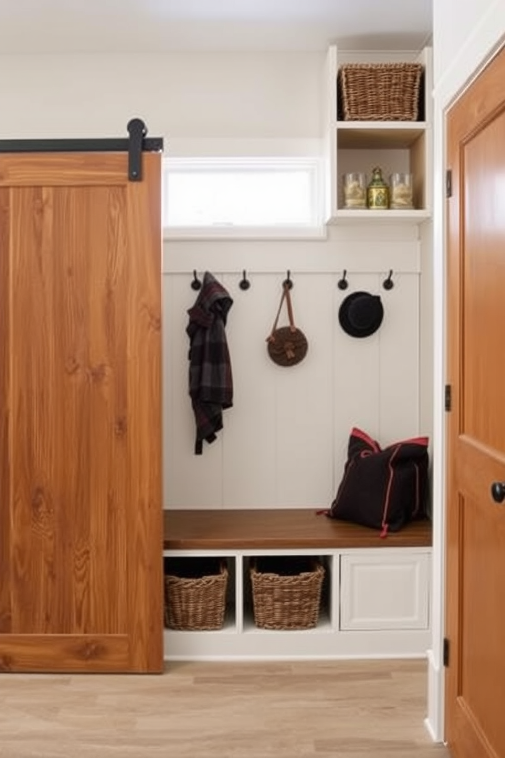 A sliding barn door adds rustic charm to the entryway while providing a functional space-saving solution. The warm wood tones of the door complement the surrounding decor, creating an inviting atmosphere. For a simple mudroom design, consider incorporating built-in benches with storage underneath. Hooks for coats and bags can be placed above the bench, keeping the space organized and clutter-free.