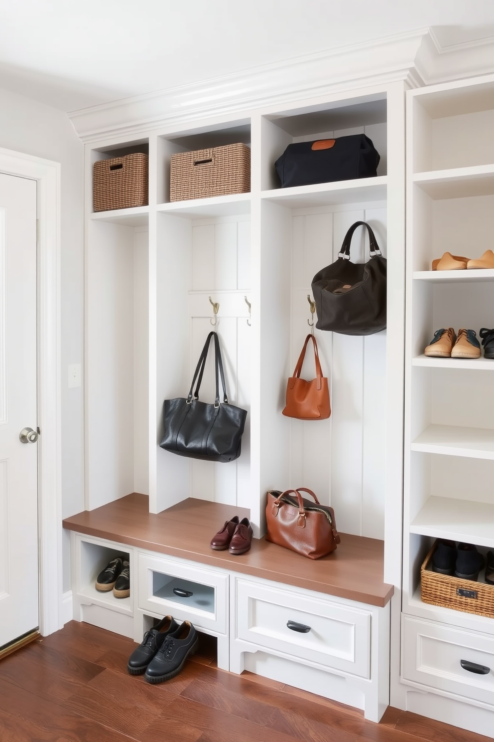 A stylish mudroom features built-in storage solutions for shoes and bags. The storage includes cubbies and hooks, with a bench for sitting and putting on shoes.