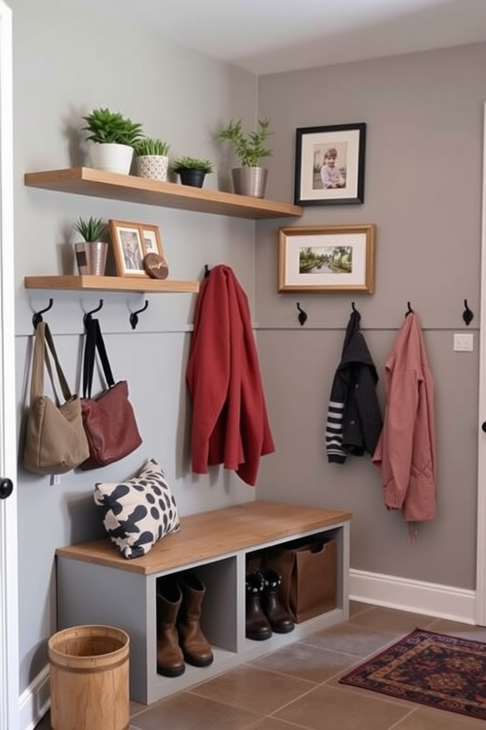 A cozy mudroom features floating shelves adorned with decorative items like potted plants and framed photos. The walls are painted in a soft gray, and a bench with storage underneath provides a functional yet stylish touch. The floor is covered in durable tile that can withstand mud and moisture, while hooks line the walls for hanging coats and bags. A small rug adds warmth and color, completing the inviting atmosphere of the space.